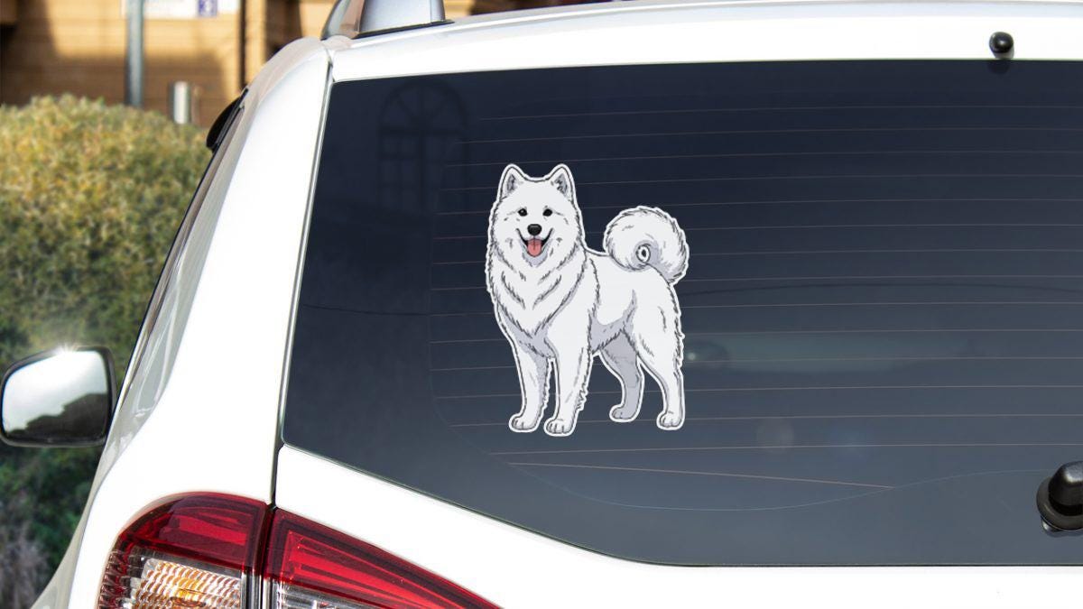 A sticker of a white Samoyed dog is displayed on the rear window of a white car.