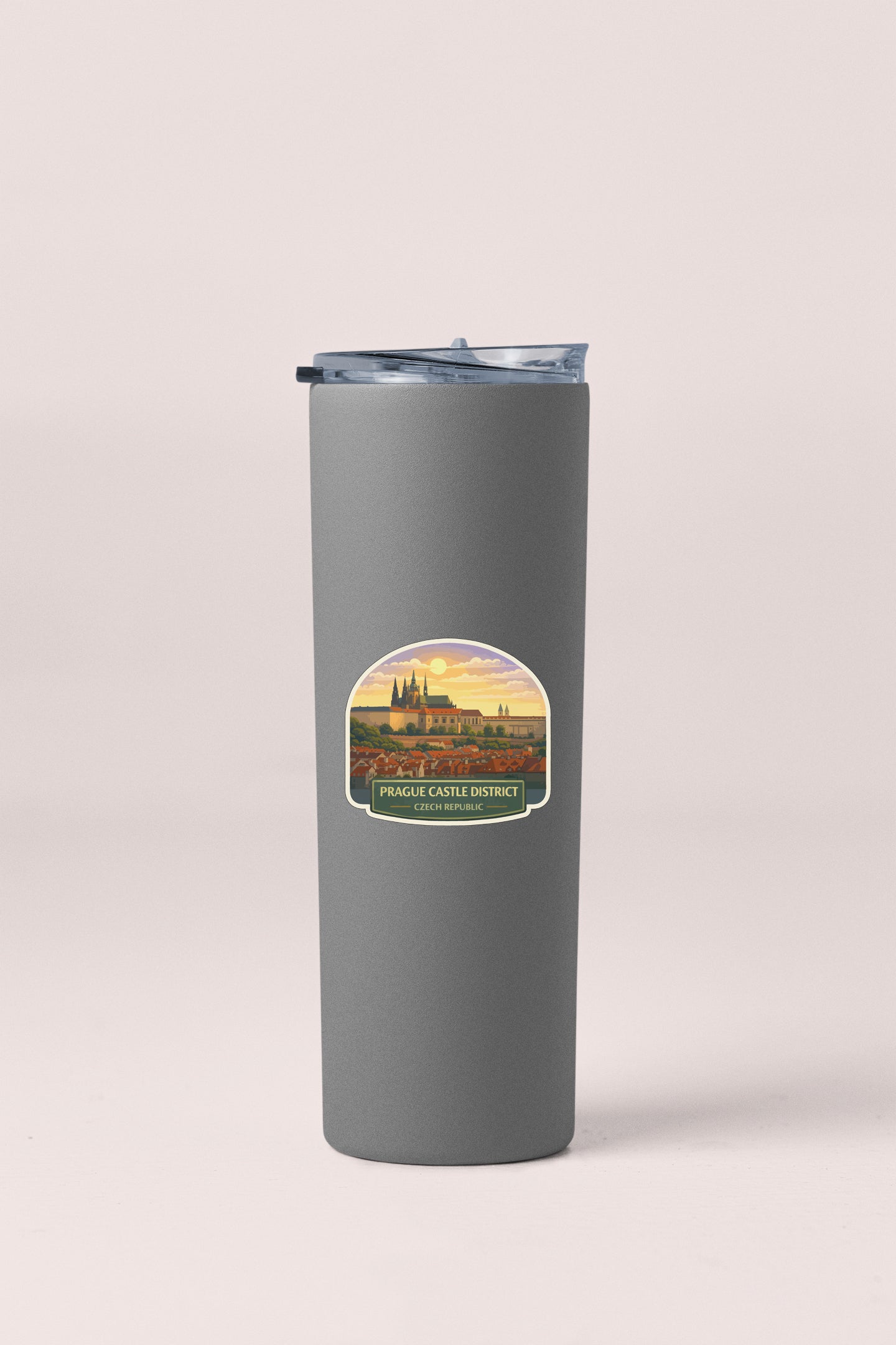 A gray insulated tumbler with a label that says "PRAGE CASTE DISTRICT" and "PRAGE CASTE REPUBLIC".