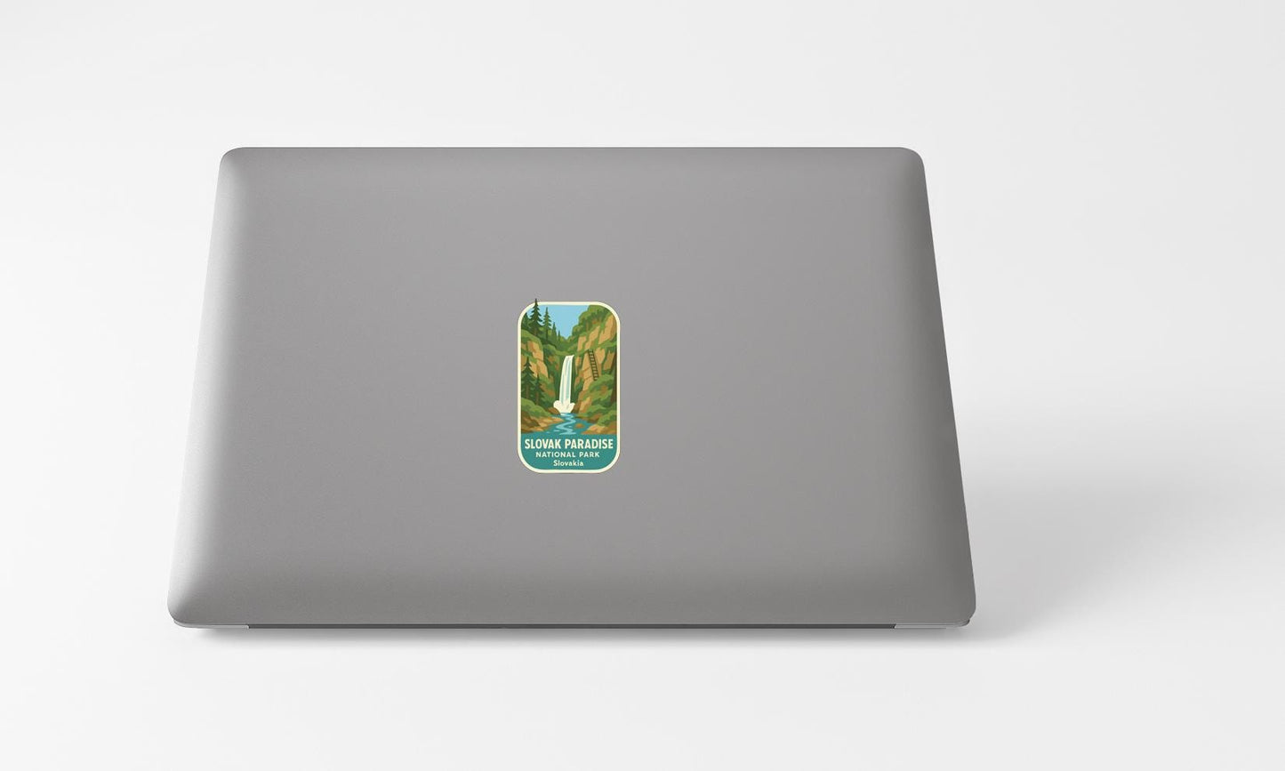 A sticker depicting a waterfall is placed on the back of a laptop computer.