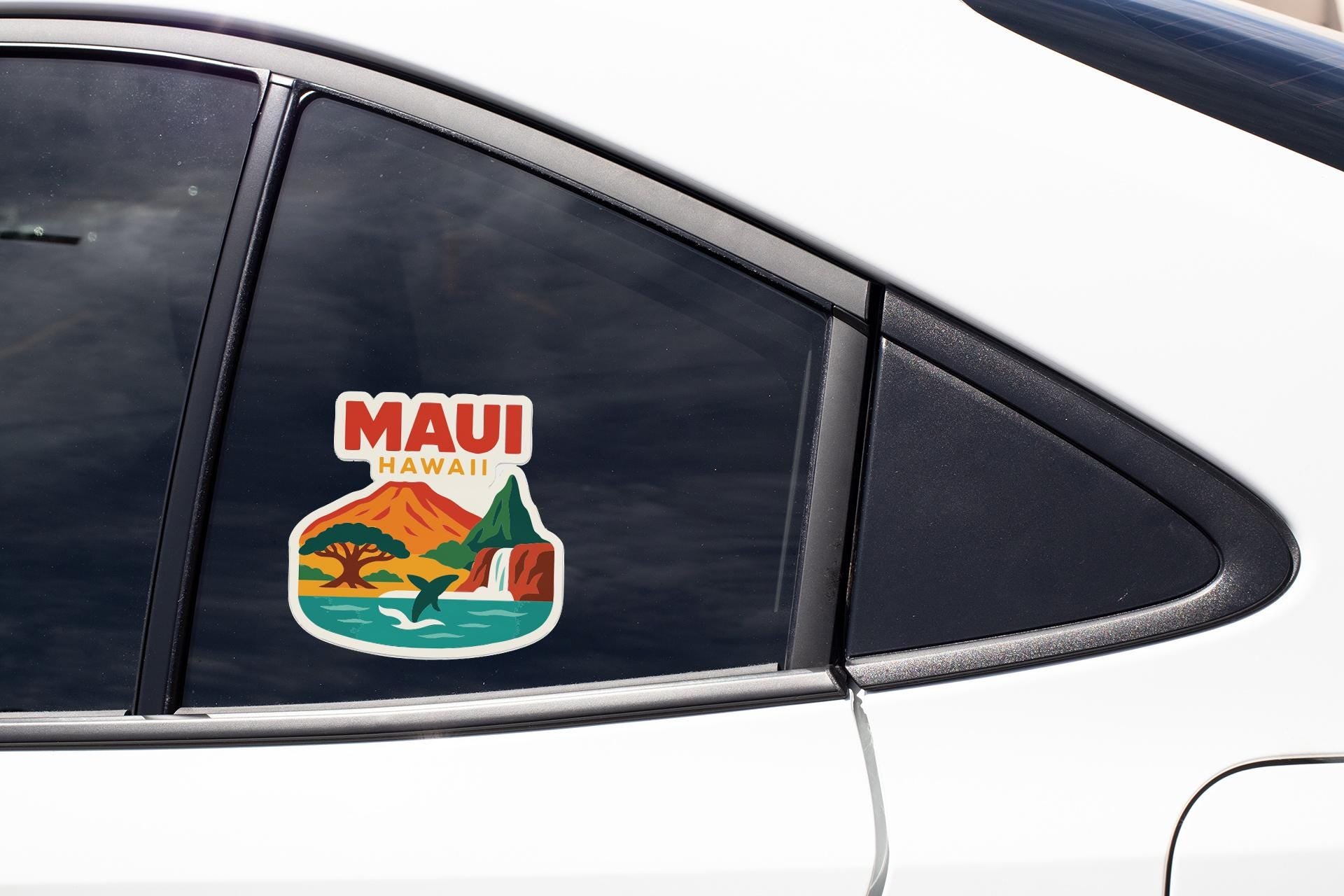 A sticker on the side of a car window that says "MAUI HAWAII".