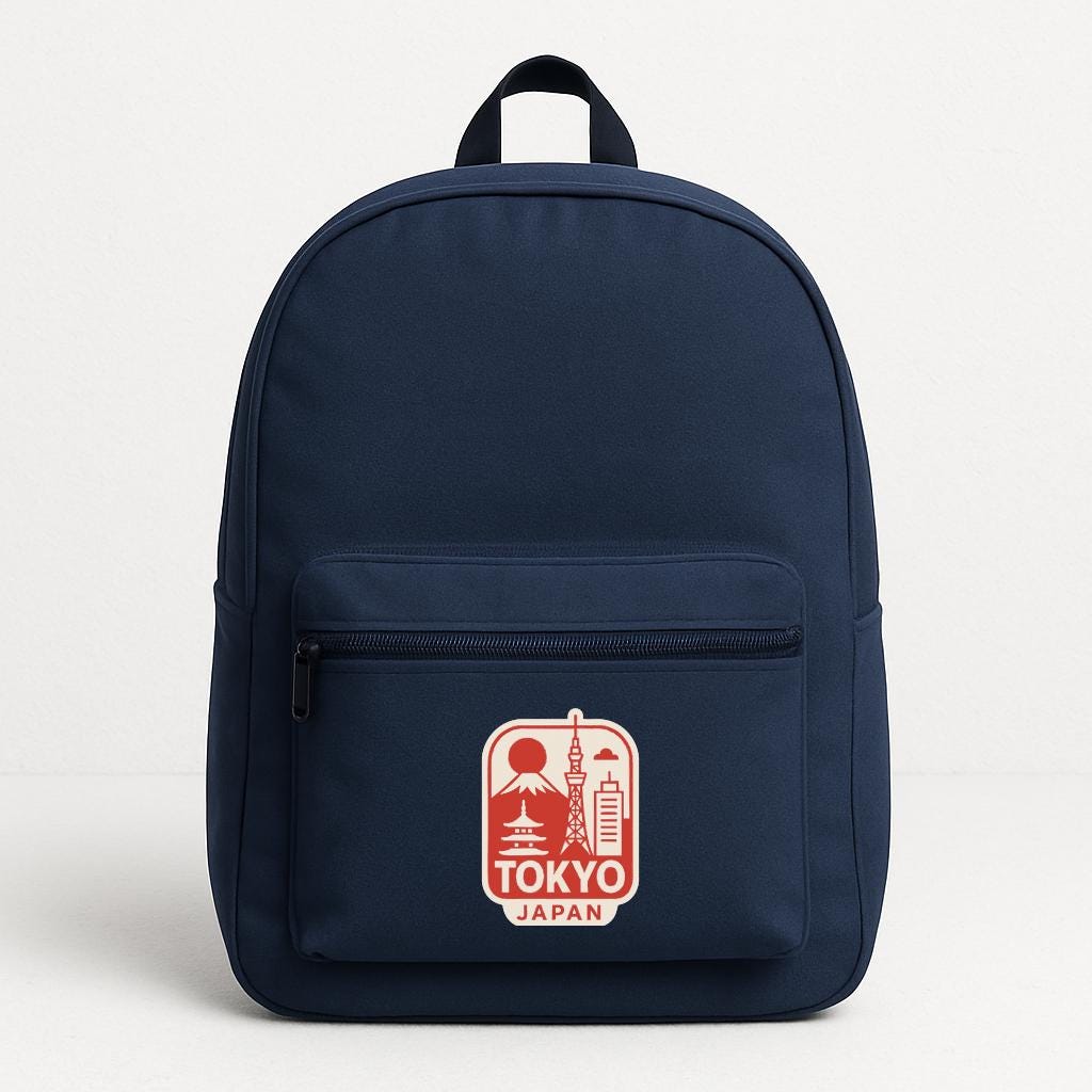 A navy blue backpack with a red and white logo that says "TOKYO JAPAN" on the front pocket.