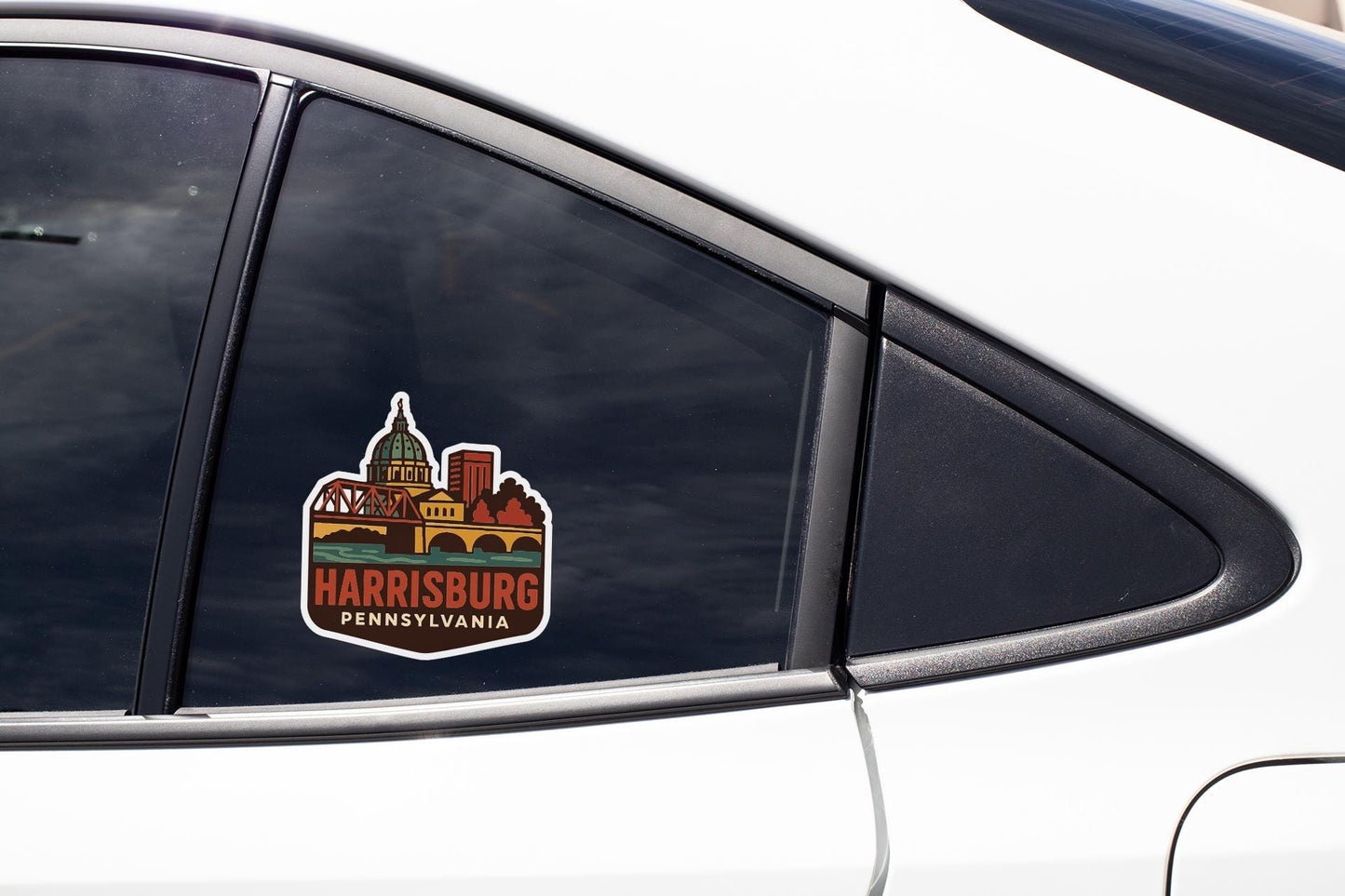A sticker on the side of a car window, depicting the Harrisburg, Pennsylvania skyline.
