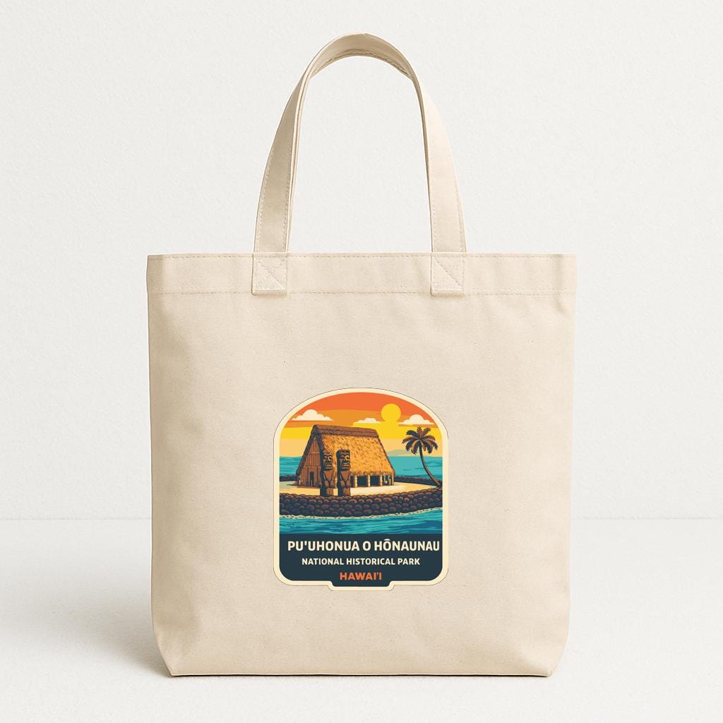 A beige tote bag with a printed label that says "PU'uhonua O Haunau National Historic Park" and features an illustration of a traditional Hawaiian hut on the beach.