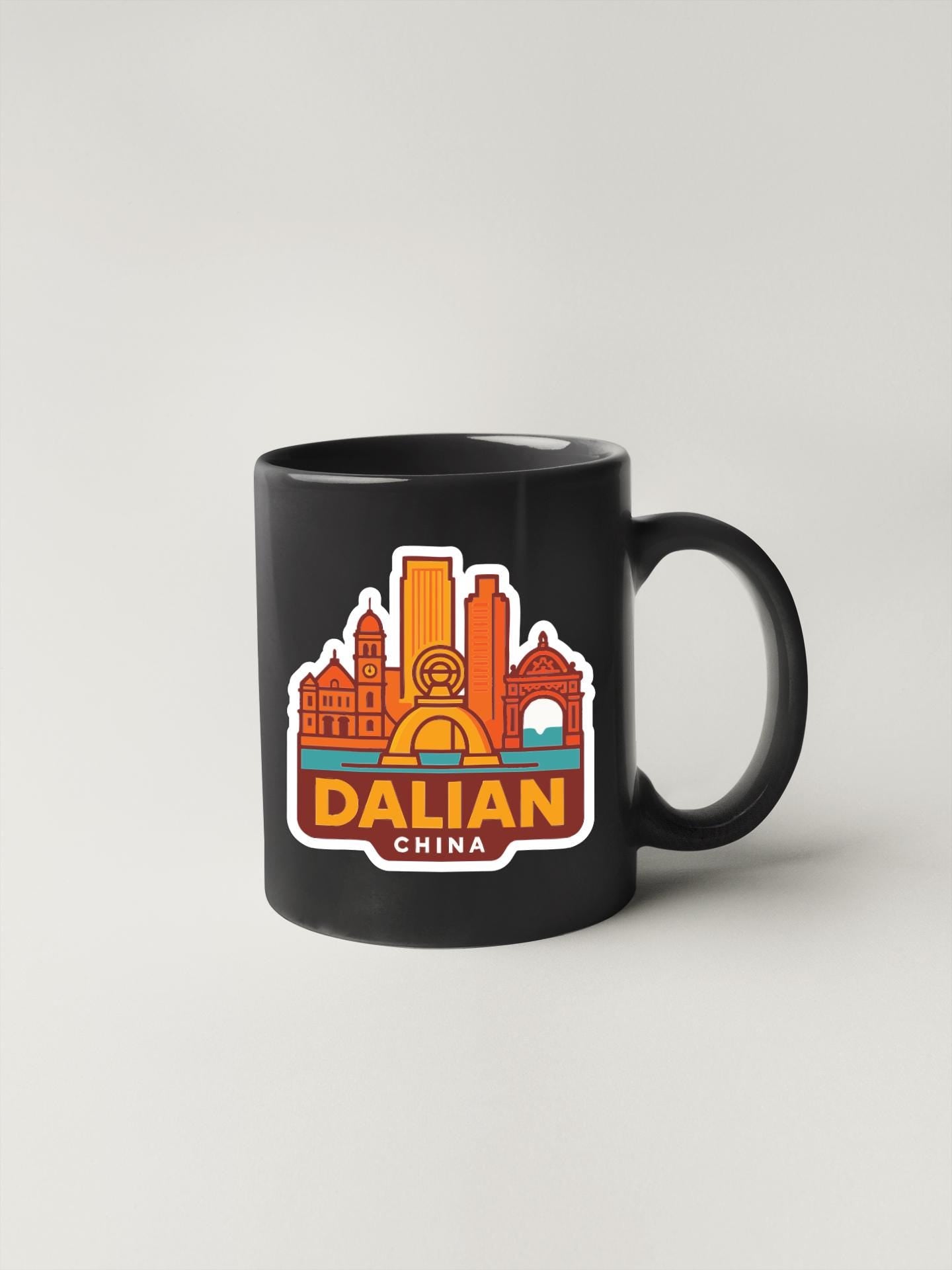 A black coffee mug with a colorful sticker depicting the skyline of Dalian, China.