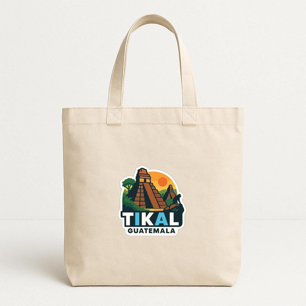 A beige tote bag with a graphic of the Mayan city of Tikal, Guatemala, printed on it.