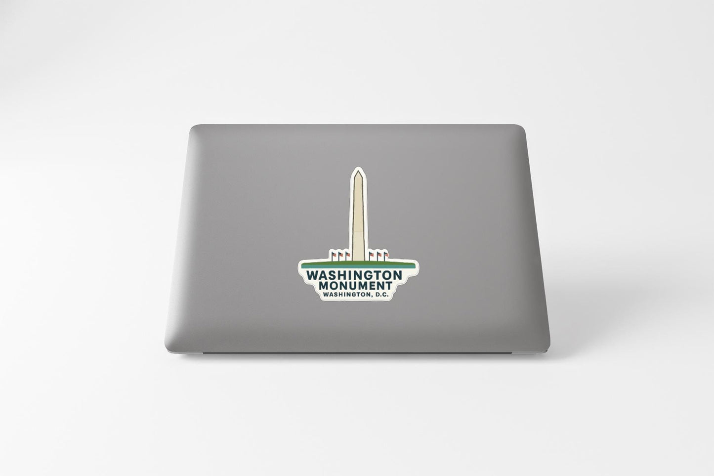 a sticker with the Washington Monument logo on the back of a laptop.