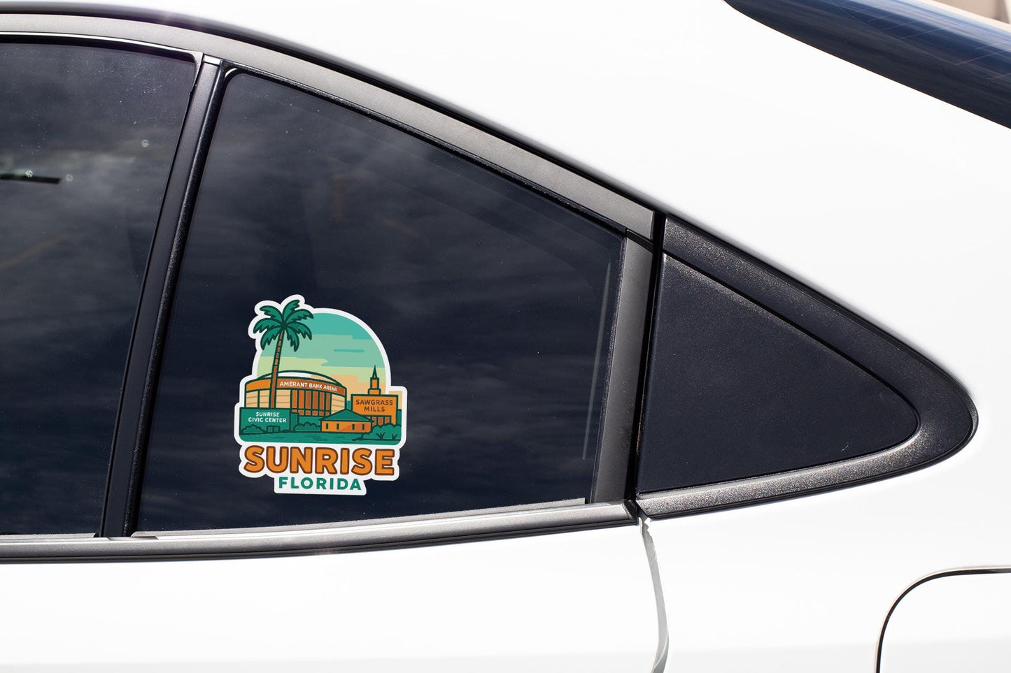 A sticker on the side of a car window depicting a tropical scene with a palm tree and a building, along with the text "SUNRISE FLORIDA".
