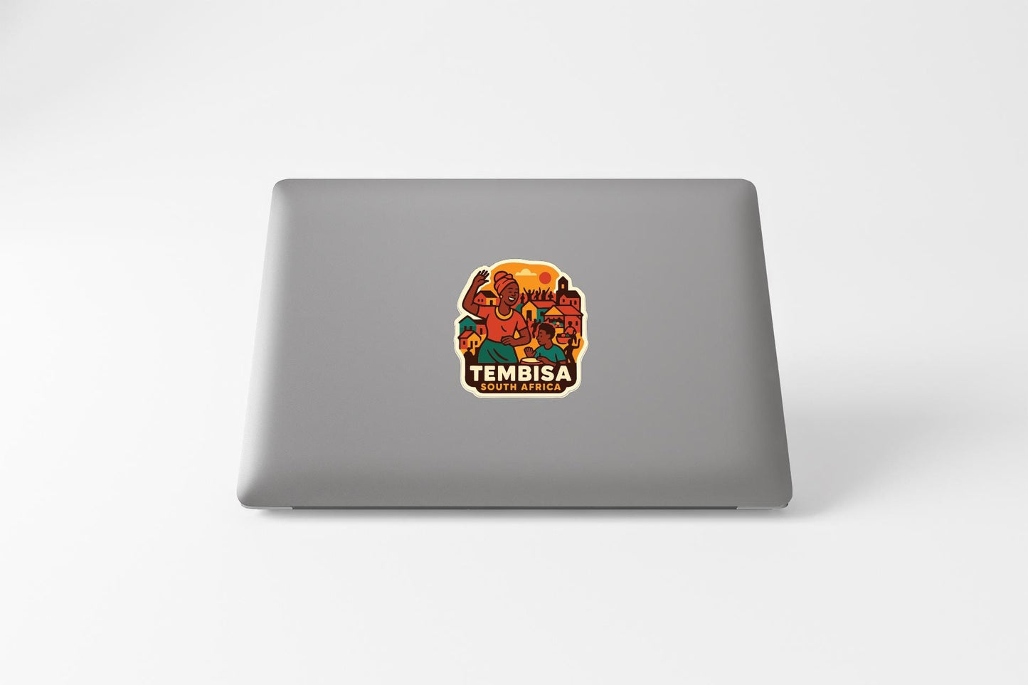a sticker with an illustration of a person and the text "TEMBISA SOUTH AFRICA" on the back of a laptop.
