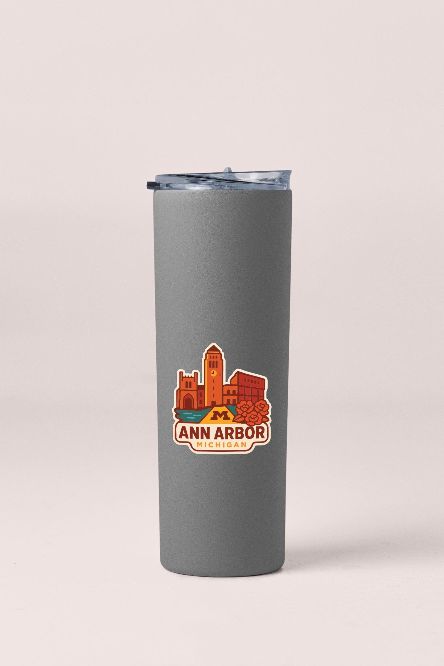 A gray insulated tumbler with a printed logo of Ann Arbor, Michigan.
