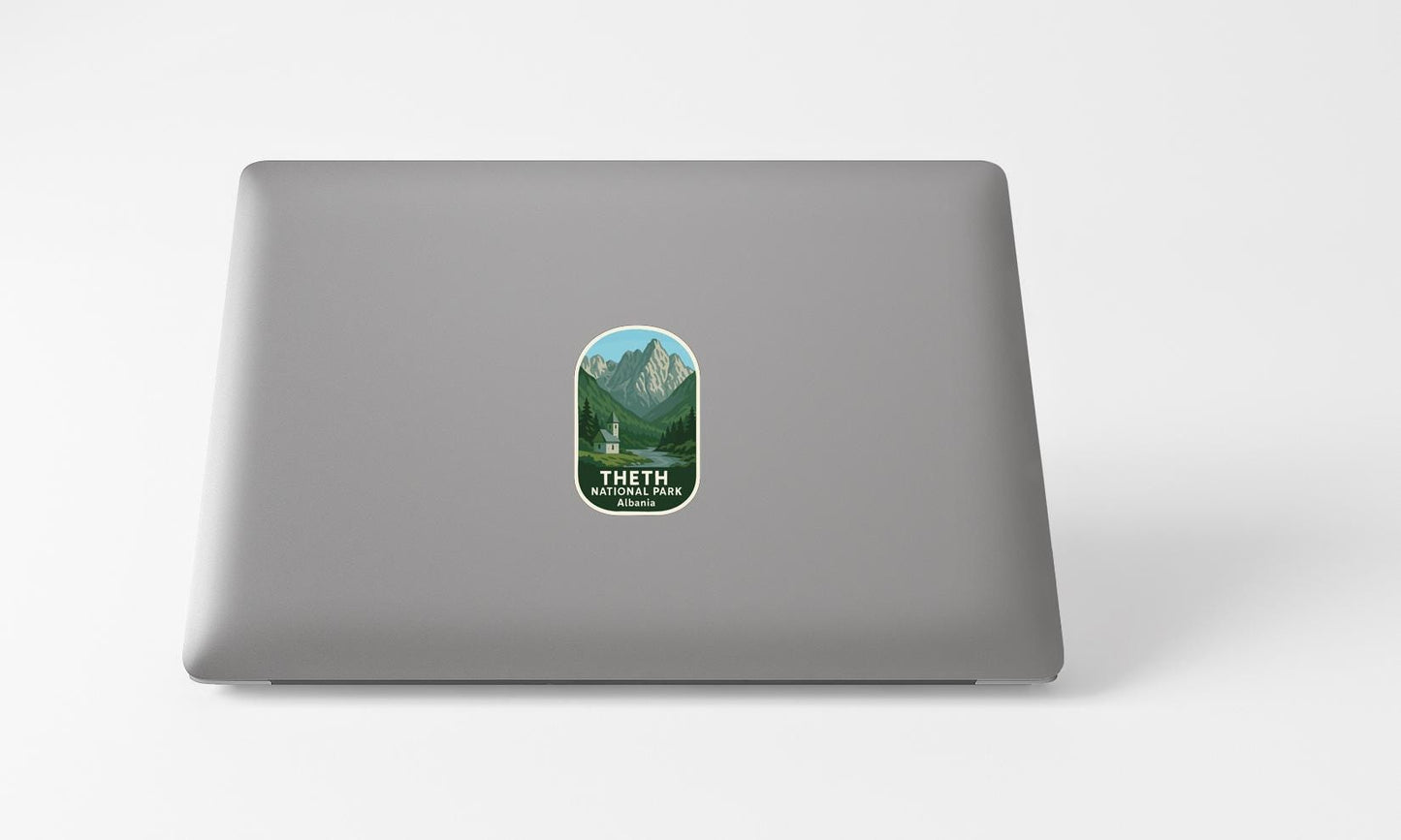 A sticker with a mountain landscape on a laptop.