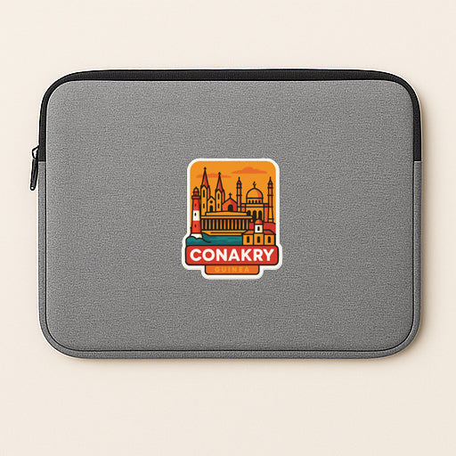 A gray laptop sleeve with a sticker depicting the city of Conakry, which is a city in the Republic of Ireland.