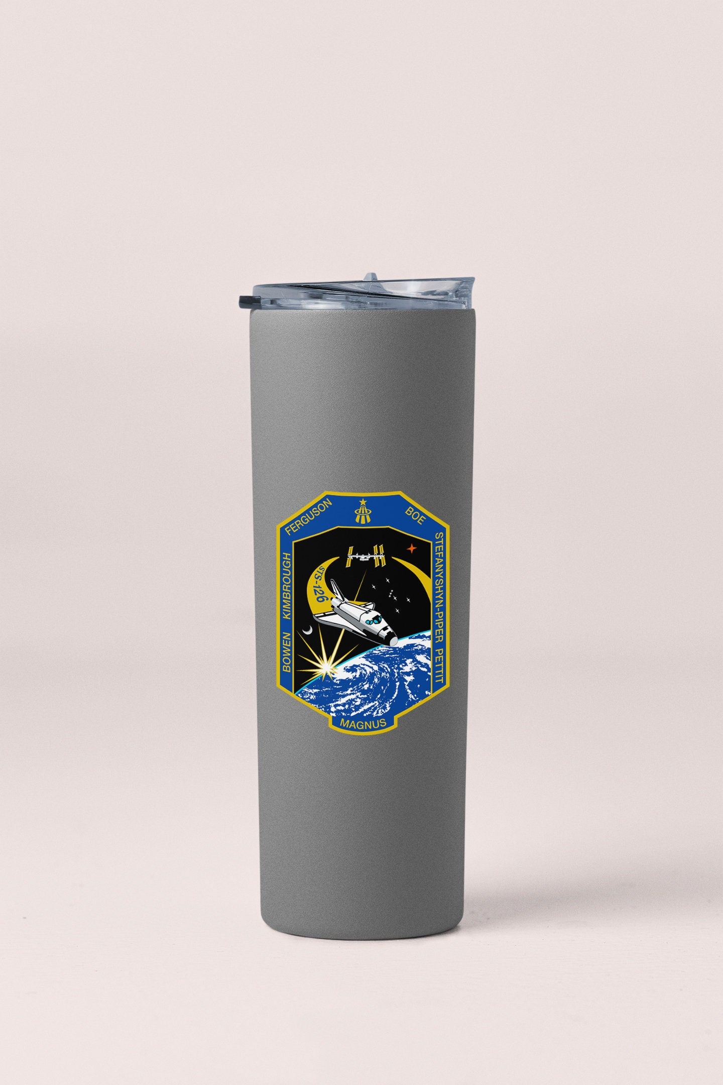 a stainless steel tumbler with a nasa emblem on it