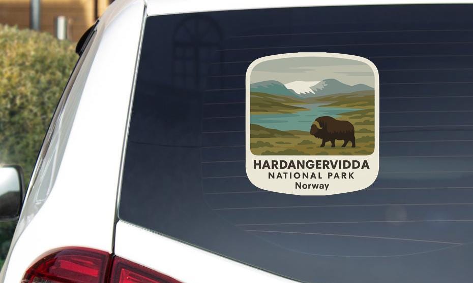 a sticker on the rear window of a car that displays a bison in a natural setting, indicating that it is from Hardangervidda National Park in Norway.