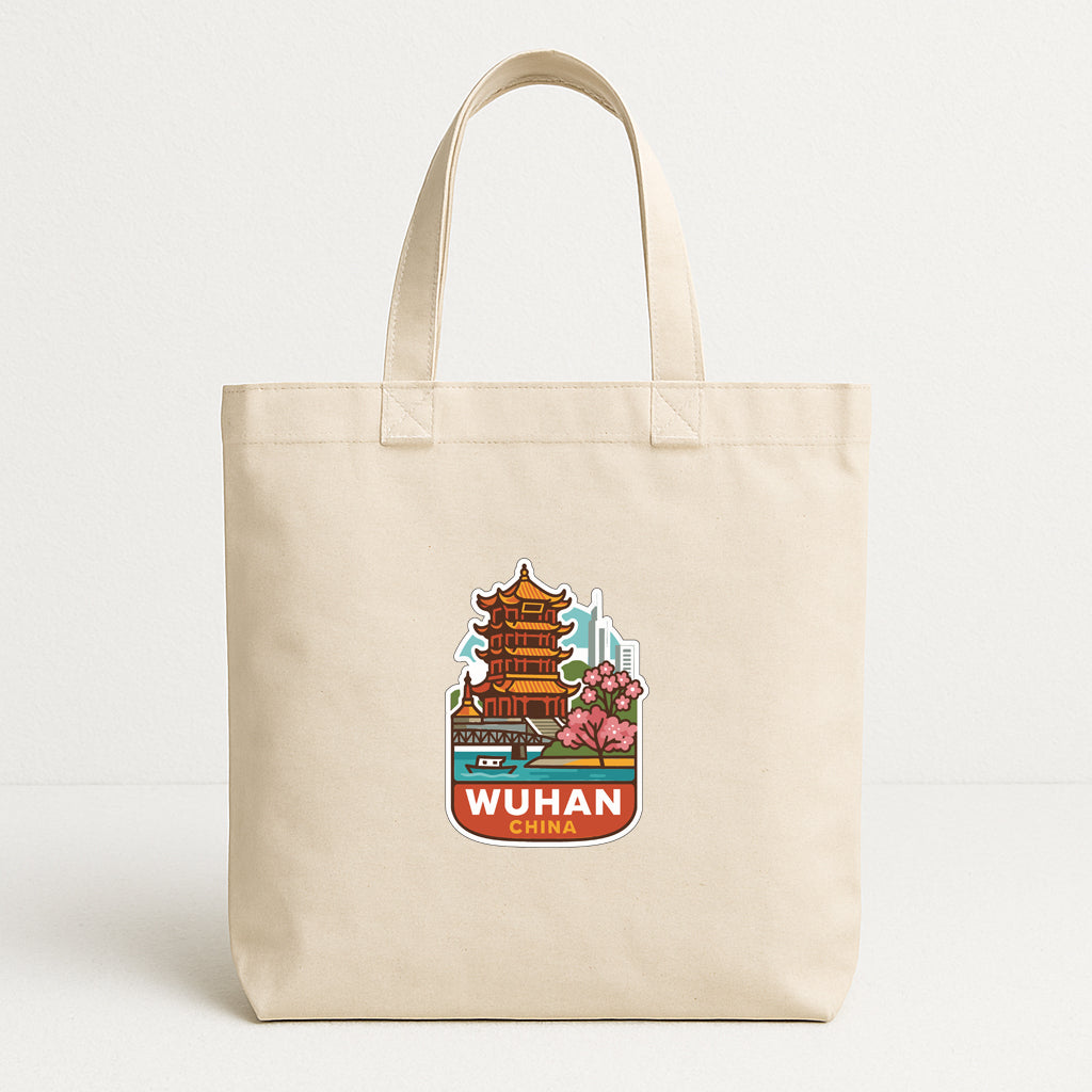 A beige tote bag with a printed design of a pagoda and the text "WUHAN CHINA" printed on it.