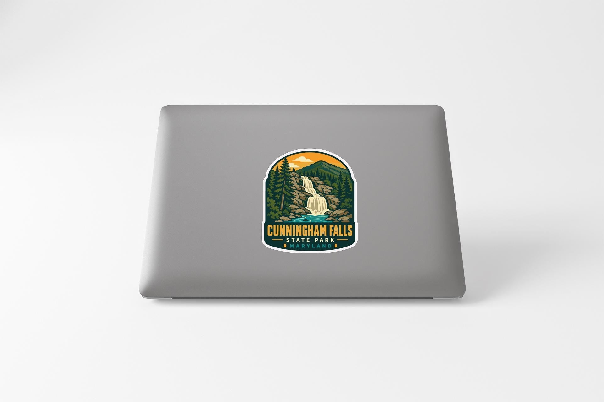 a sticker or decal of Cunningham Falls State Park on the back of a laptop computer.