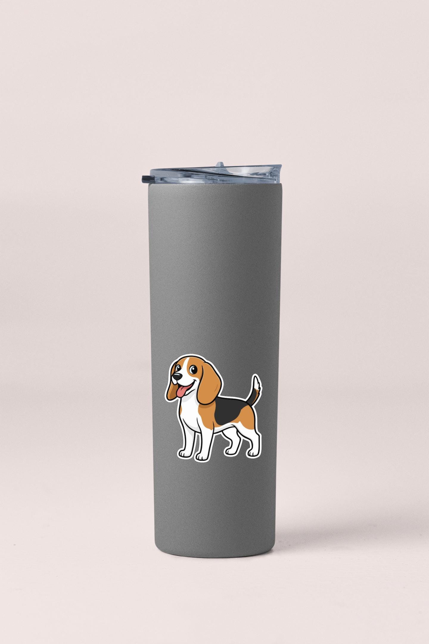 A gray insulated tumbler with a sticker of a cartoon dog on it.