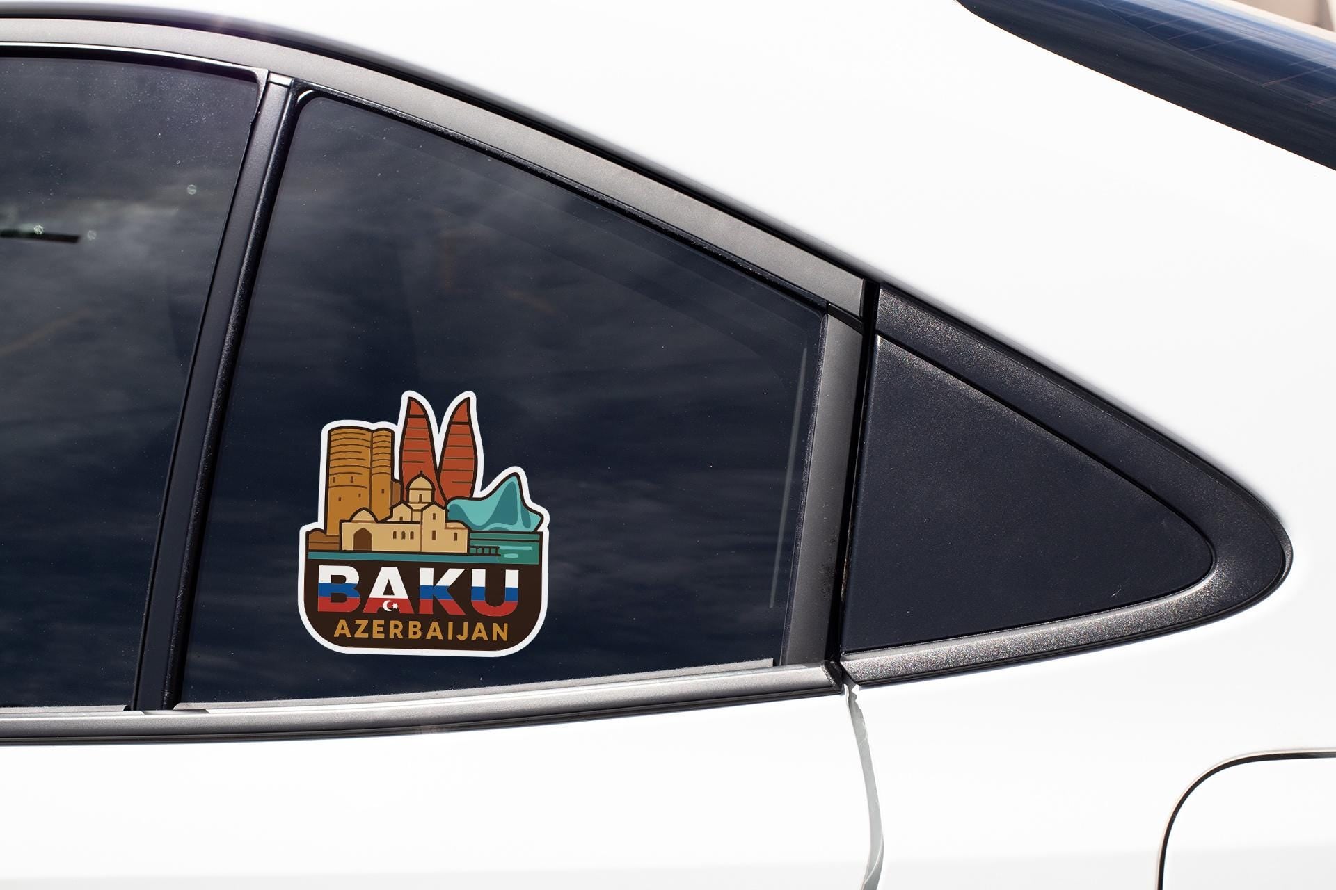A sticker on the side of a car window, depicting the city of Daku, Azerbaijan.