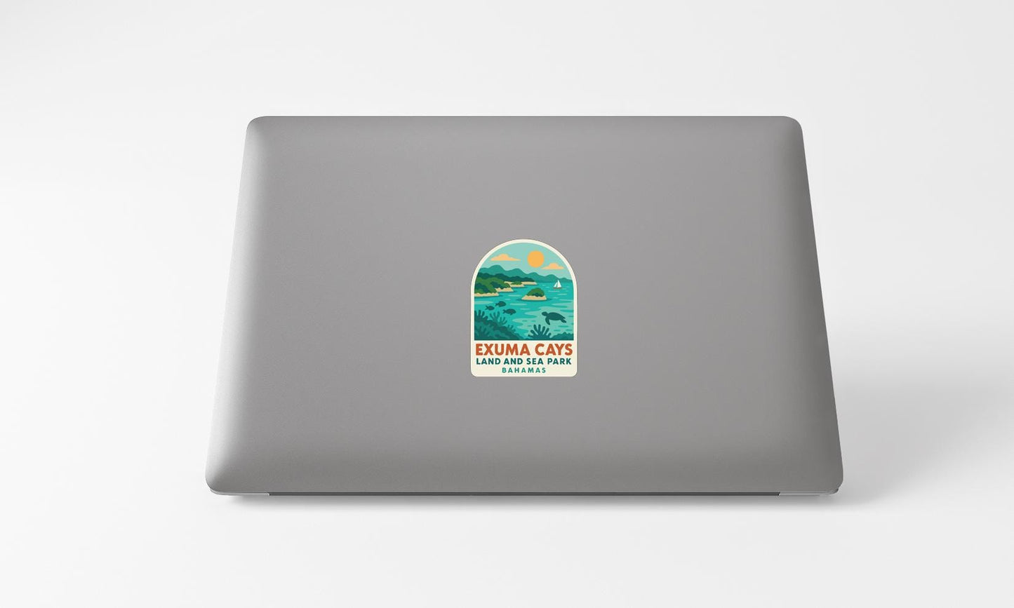A sticker on the back of a laptop, depicting a scenic landscape with a lake and mountains.