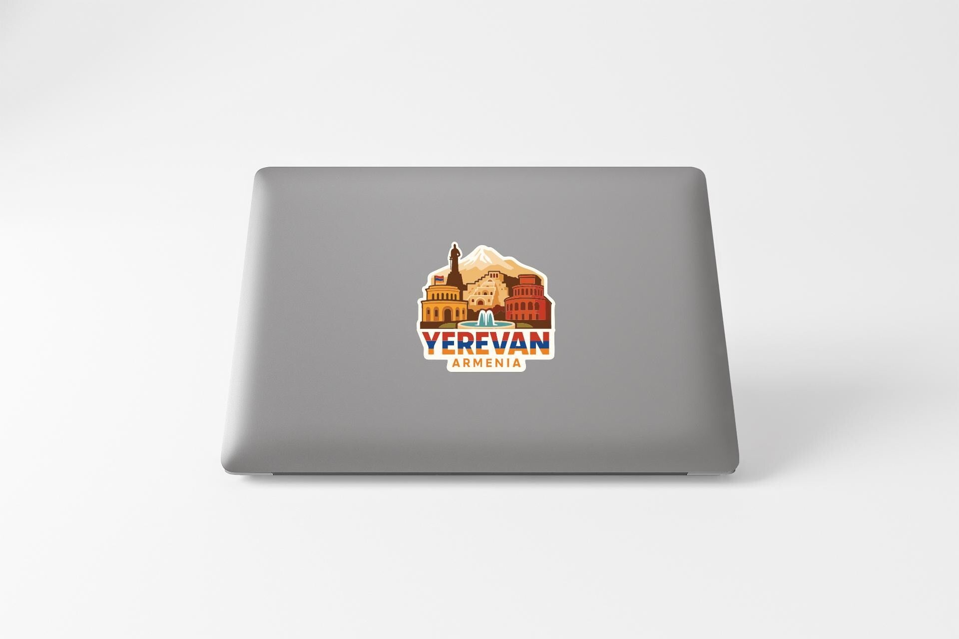 a sticker with a graphic of a building and mountains, along with the text "YEREVAN ARENIA".