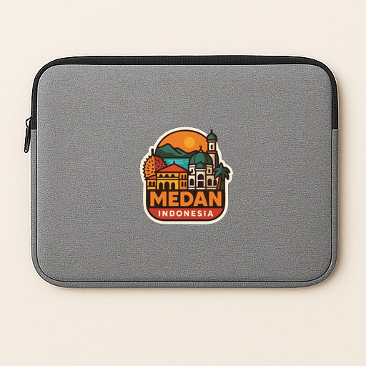 a gray laptop sleeve with a sticker of Medan, Indonesia, which is a city in Indonesia.
