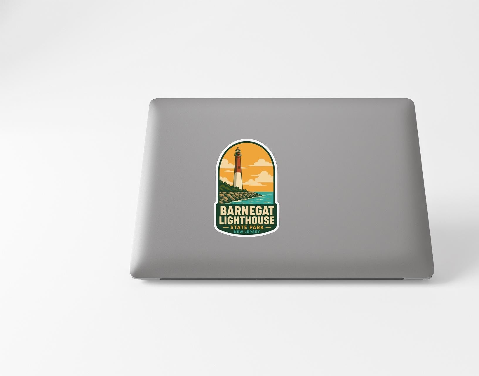 a sticker with a lighthouse on a laptop.