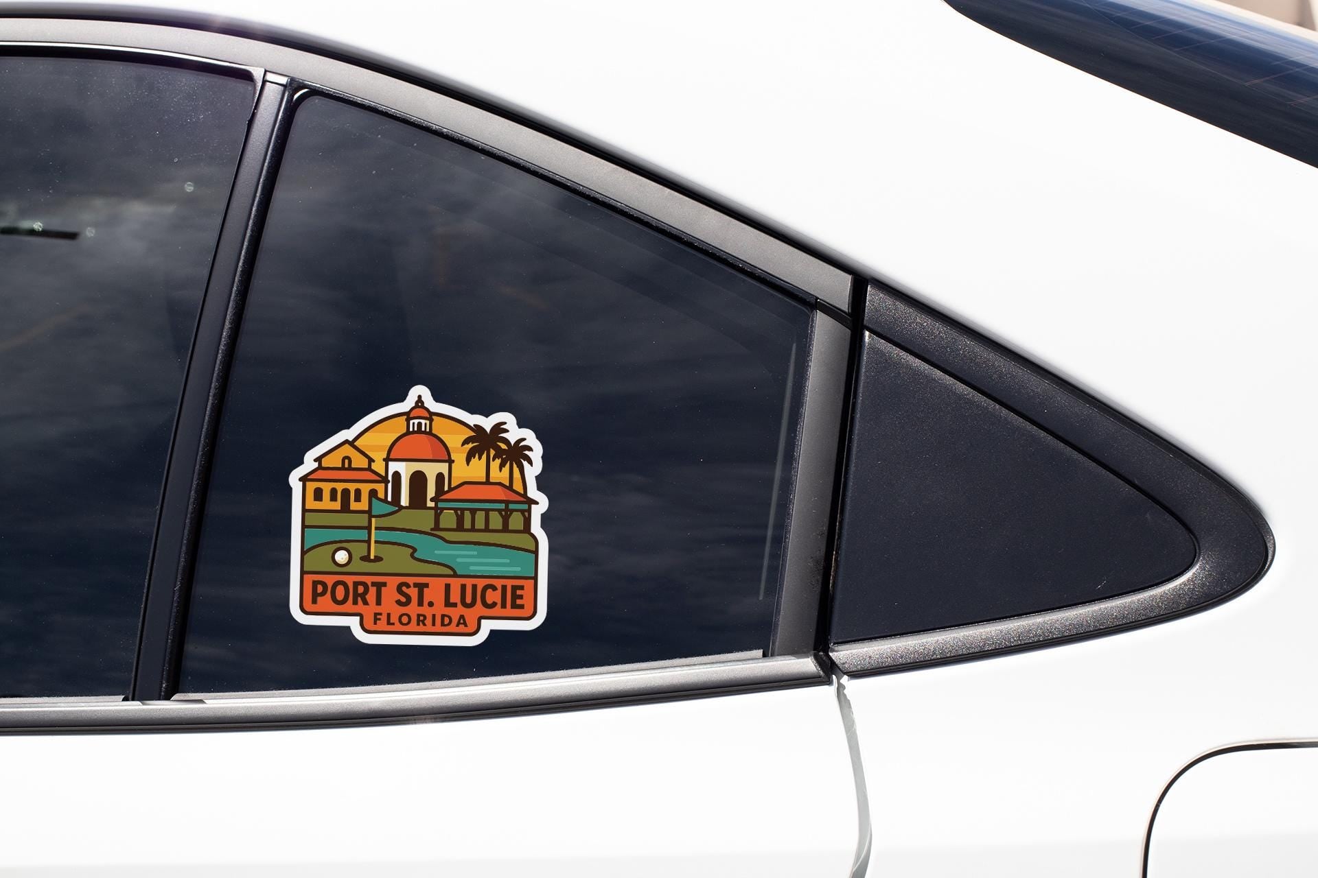 A sticker on the side of a car window, depicting a tropical resort with palm trees and a building with a dome.