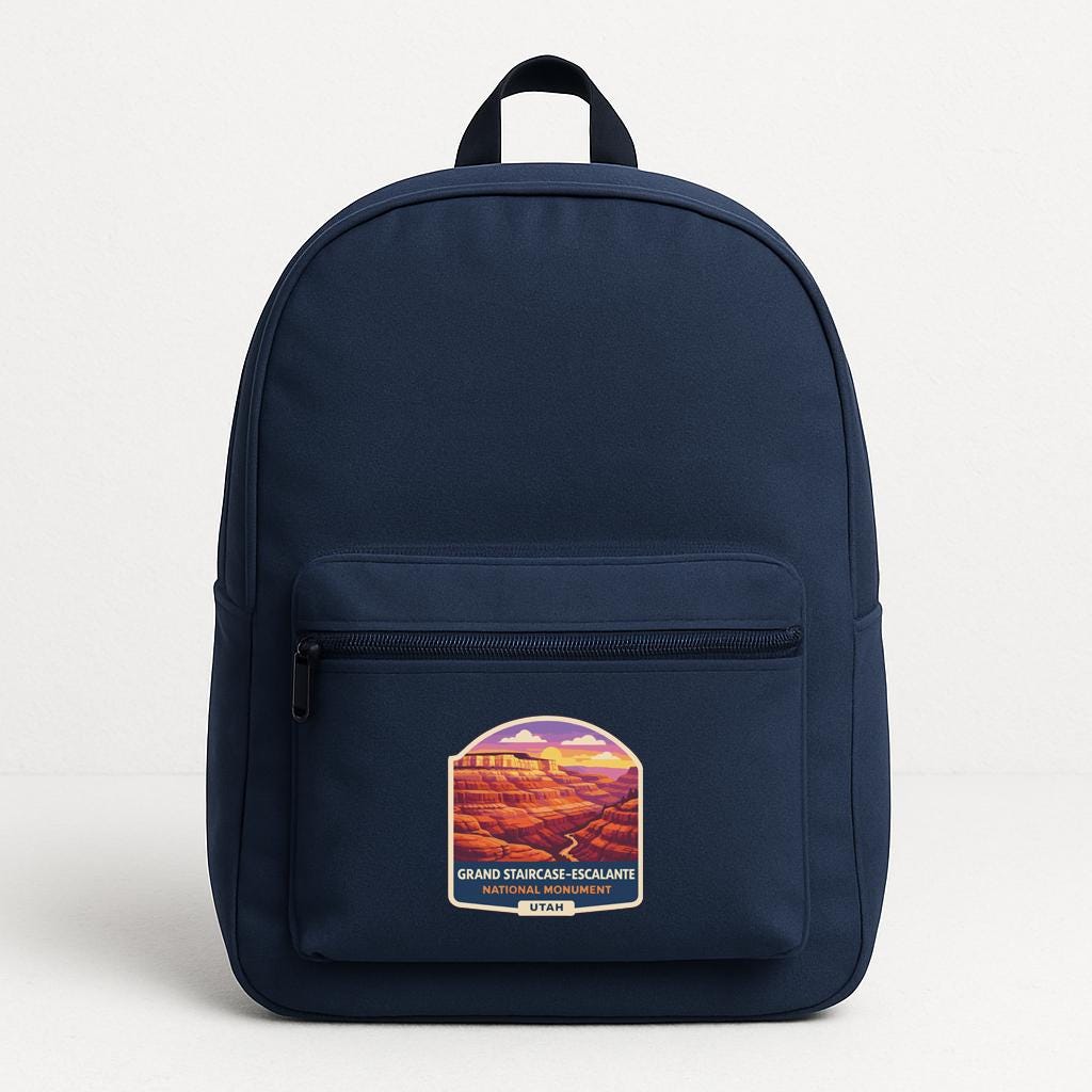 A navy blue backpack with a graphic of a mountain range on the front pocket.