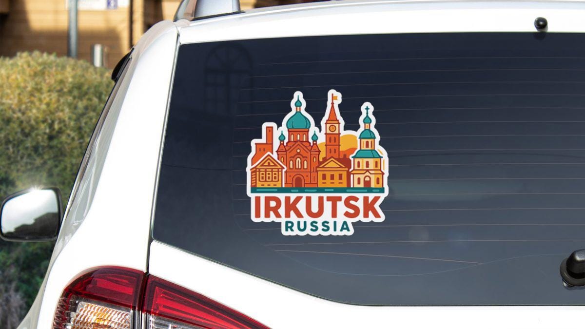 A sticker on the rear window of a car that features an illustration of a Russian cityscape with the text "IRKUTSK RUSSIA".