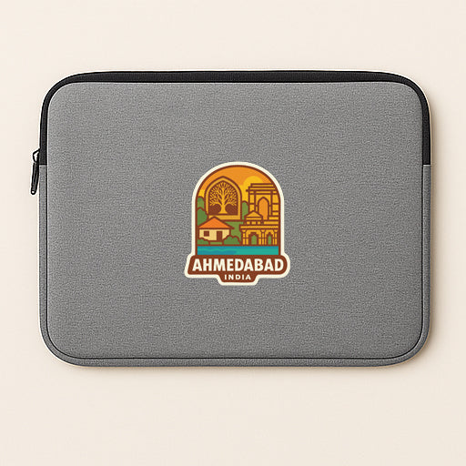 A gray laptop sleeve with a sticker of the city of Ahmedabad, India, printed on it.