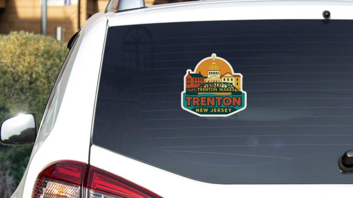 A sticker on the rear window of a white car, displaying the name 'Trenton' and the location 'New Jersey'.