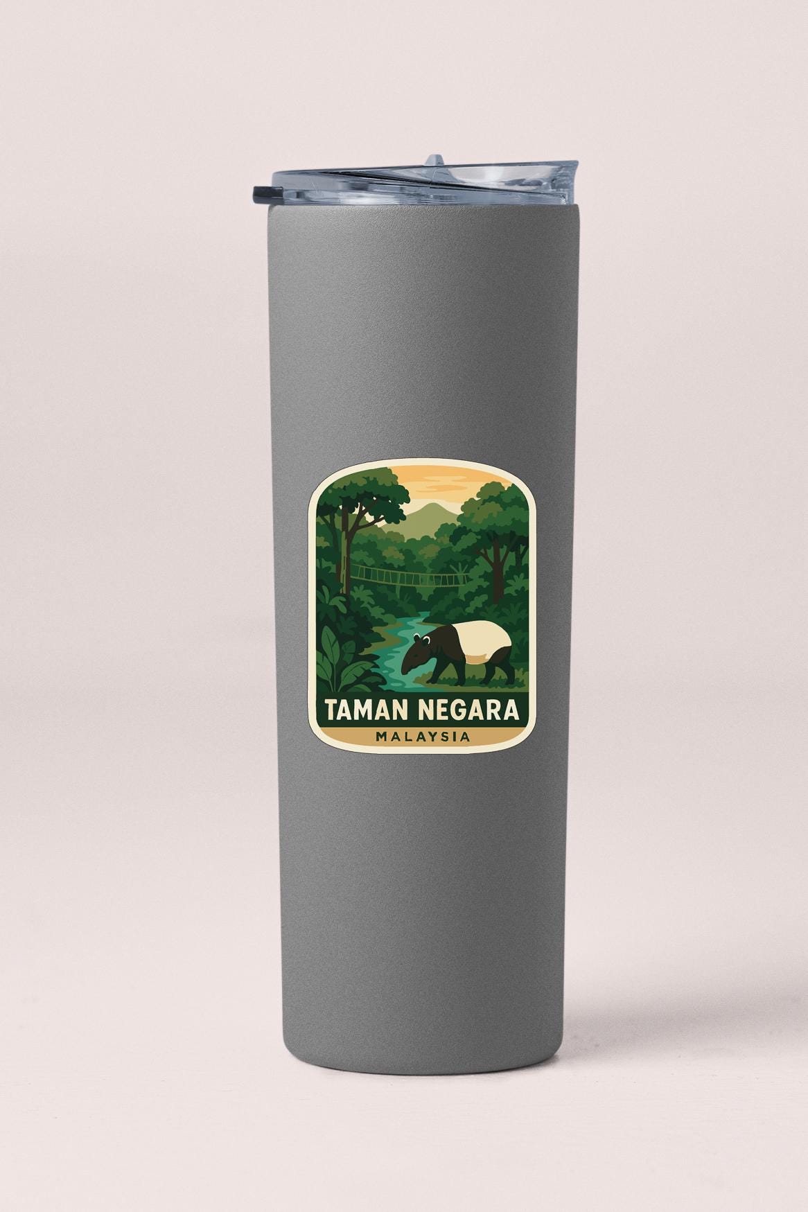 A gray tumbler with a sticker depicting a scenic landscape of Taman Negara, Malaysia.