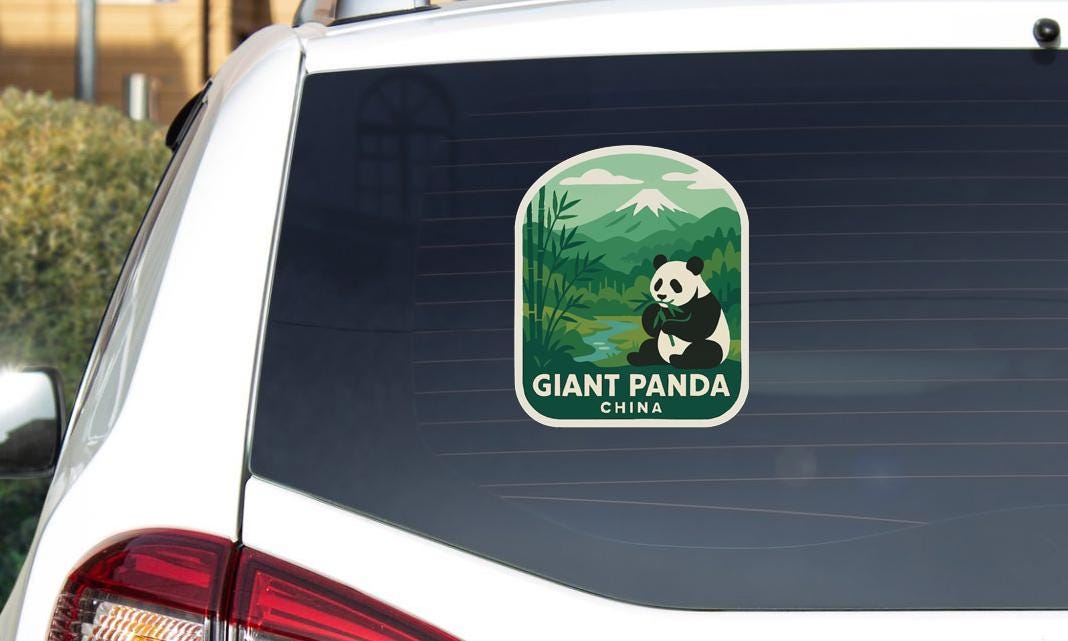 A sticker on the rear window of a car featuring a panda bear and the text "GIANT PANDA CHINA".