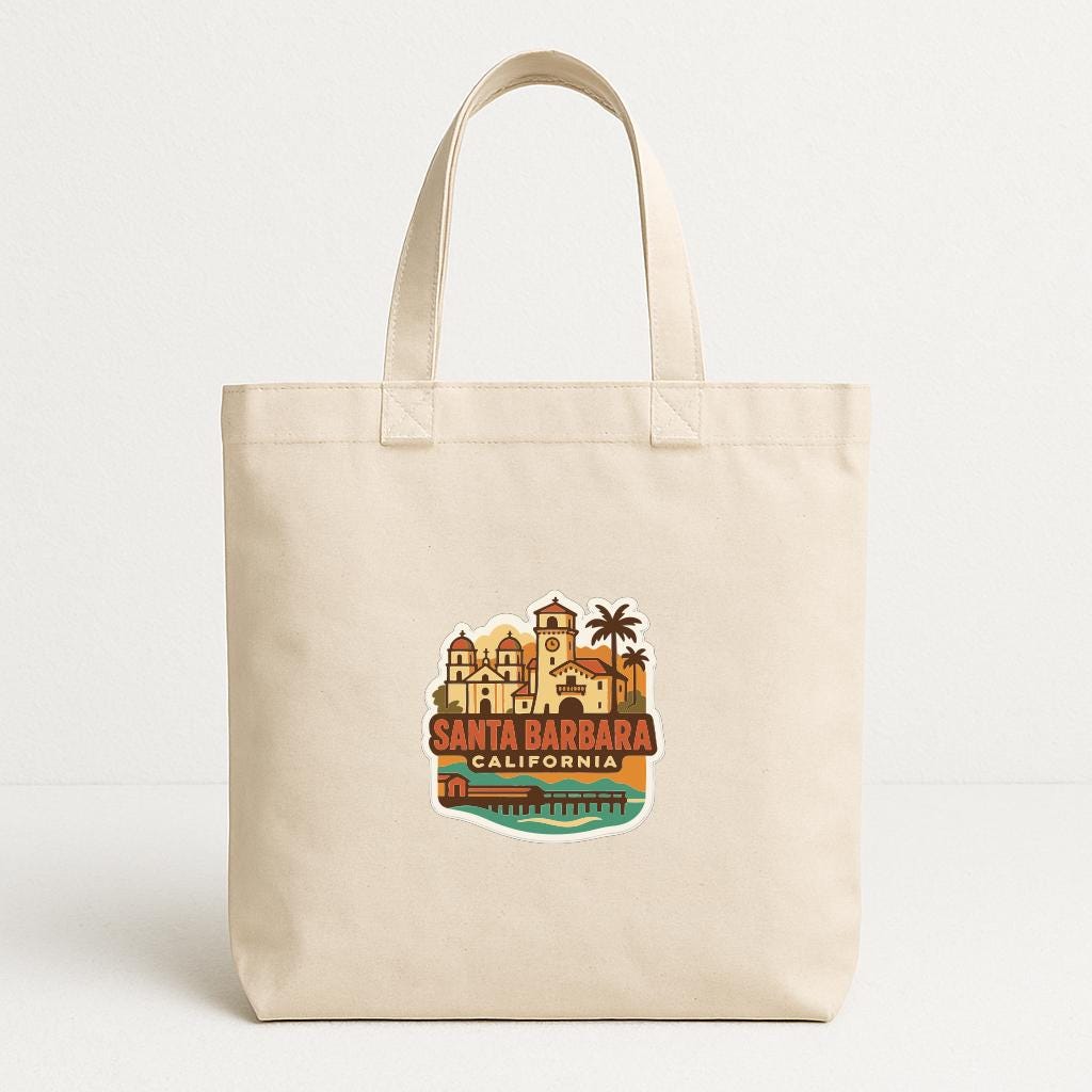 A beige tote bag with a printed design depicting Santa Barbara, California.