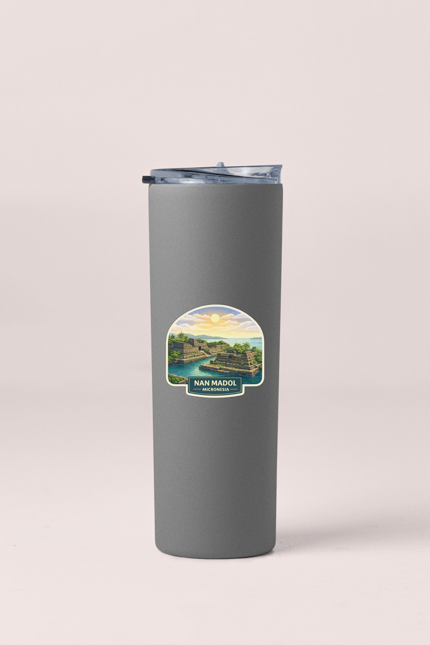 A gray insulated tumbler with a label depicting a scenic landscape.
