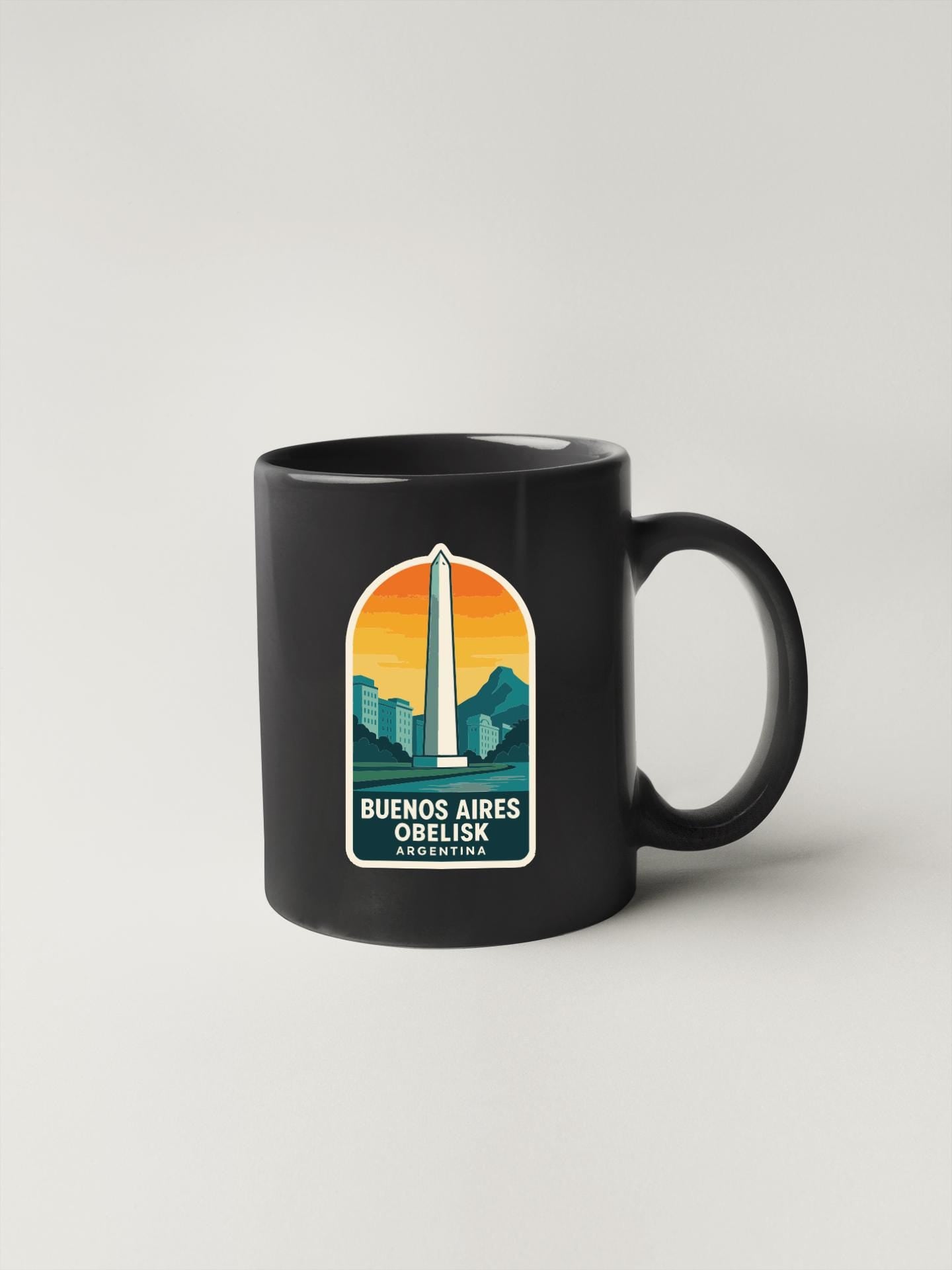 A black coffee mug with a graphic design featuring the Washington Monument and the text "Buenos Aires Obelisk Argentina" printed on it.