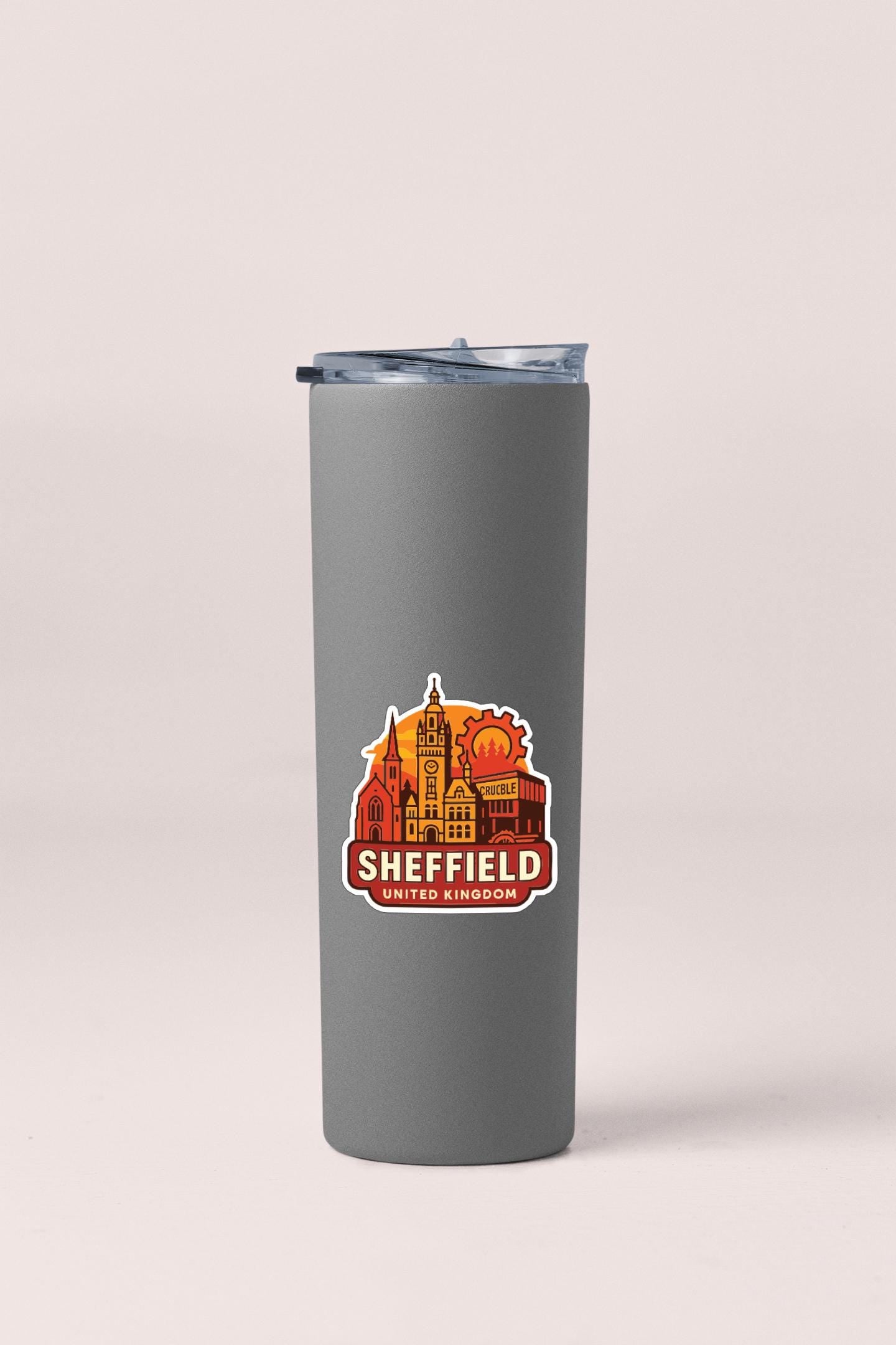 A gray insulated tumbler with a sticker depicting the skyline of Sheffield, UK.