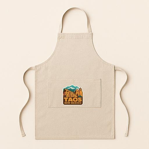 A beige apricot with a graphic of a Mexican landmark, specifically the Taqueria de Taos, printed on it.