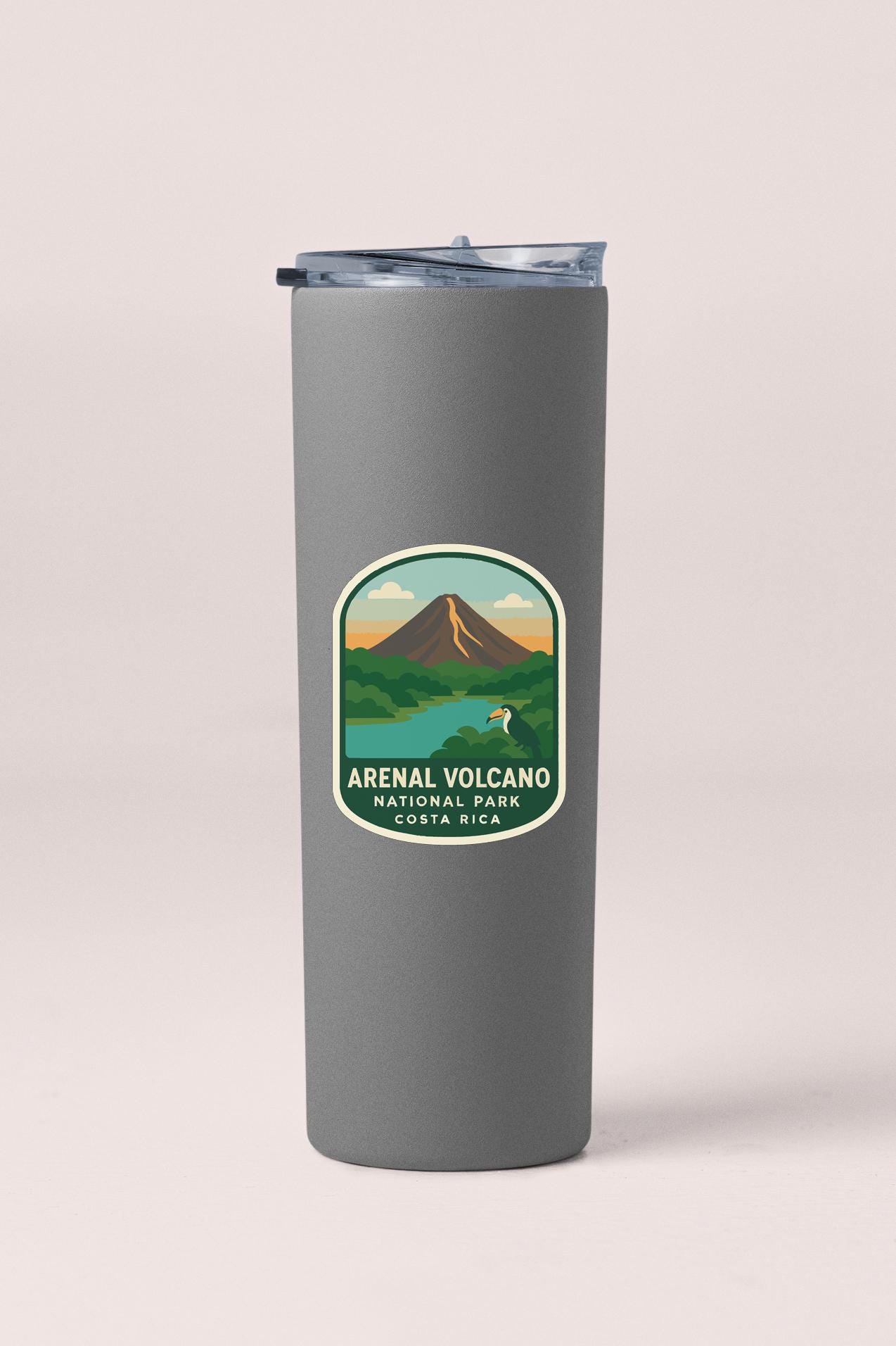 A gray insulated tumbler with a label that says "ARENAAL VOLCANO NATIONAL PARK COSTA RICA".