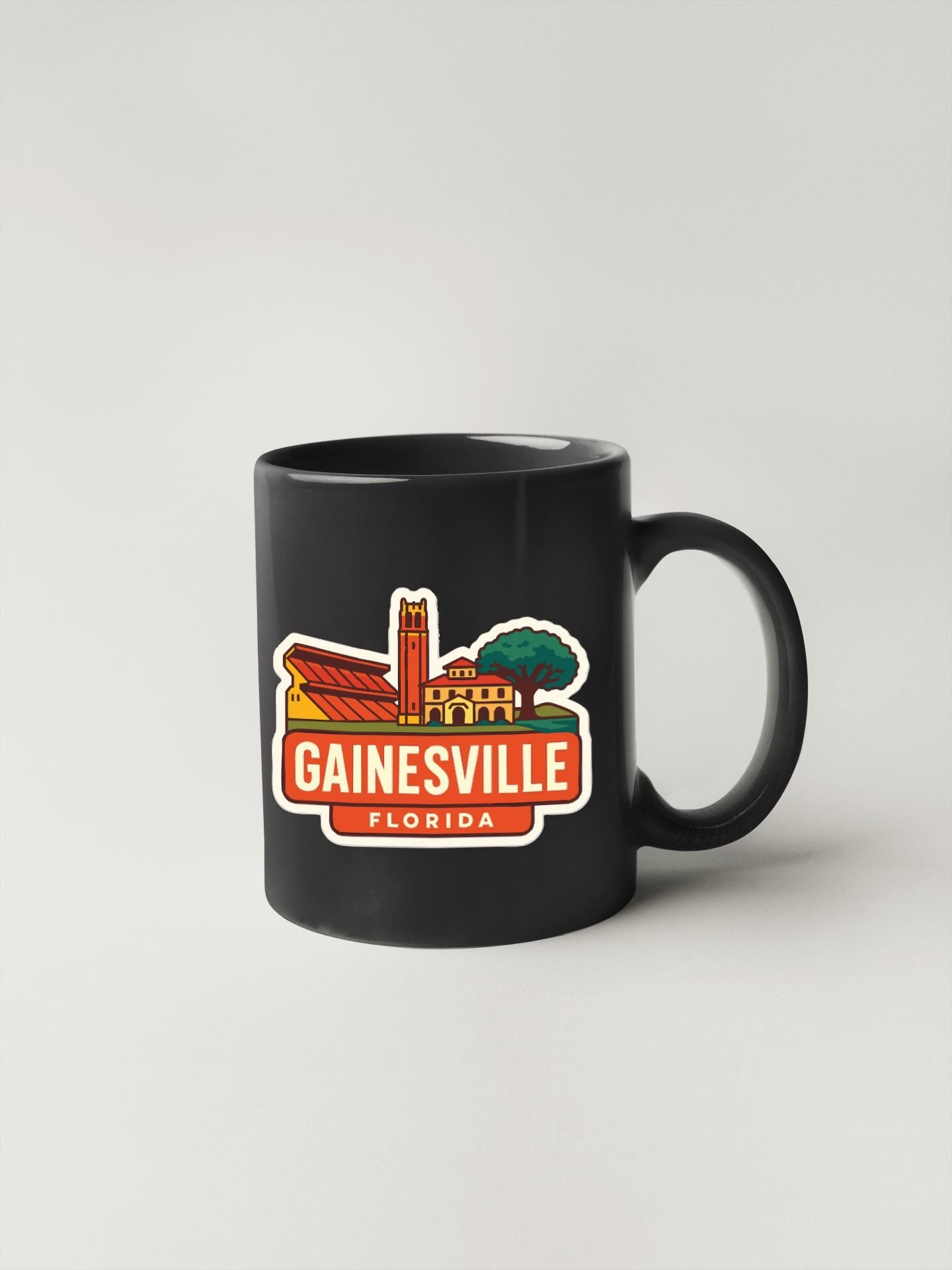 A black coffee mug with a graphic design depicting the city of Gainesville, Florida.