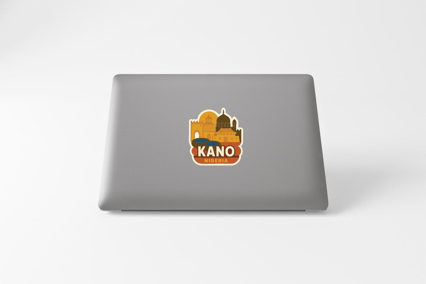 a sticker or logo on the back of a laptop, depicting a cityscape with a prominent building.