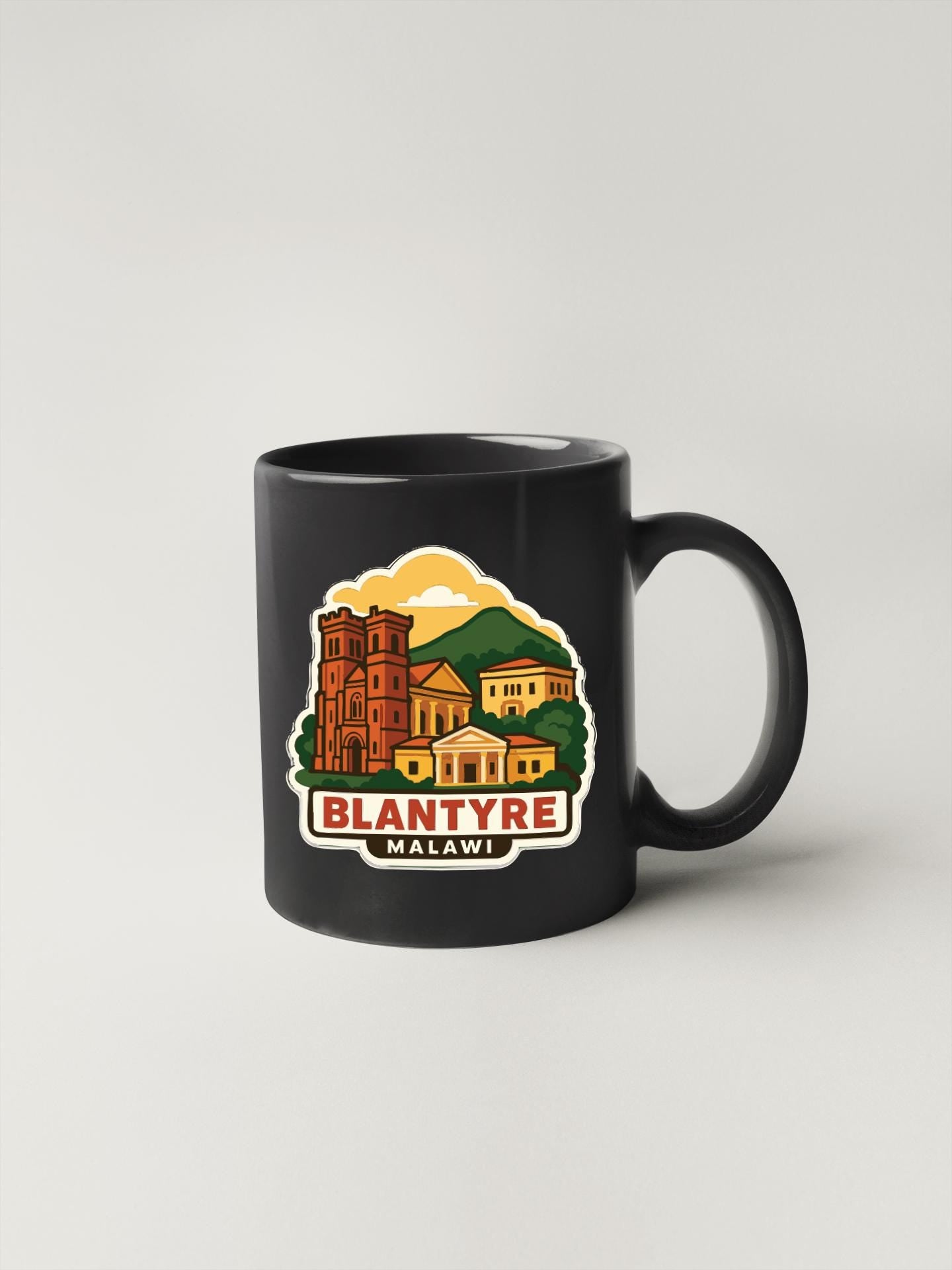 A black coffee mug with a colorful illustration of a town or village, along with the text "BLANTYRE MALAWI" printed on it.