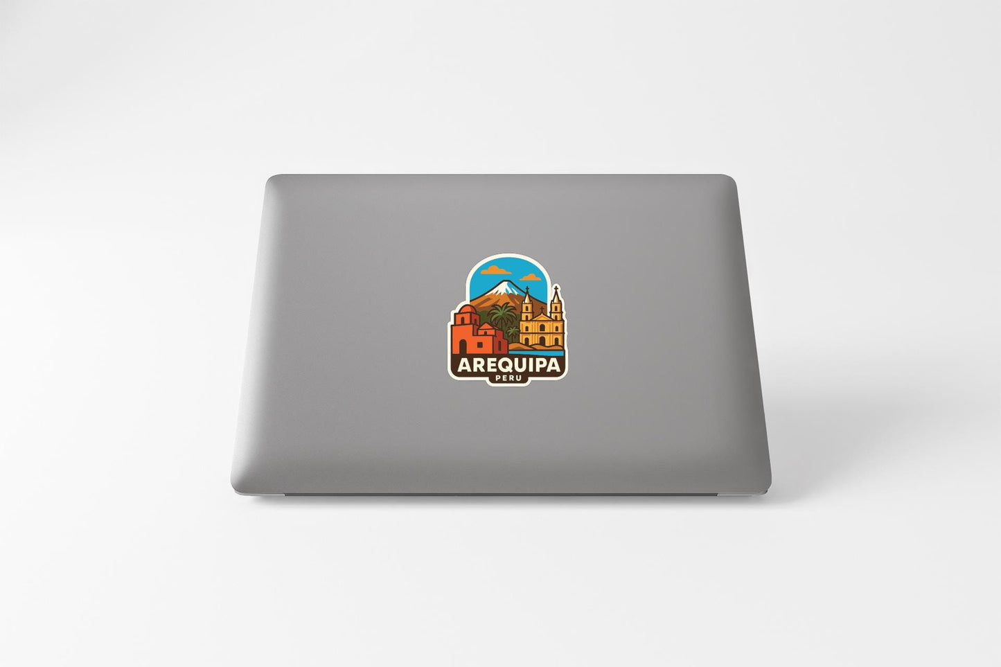 a sticker with a colorful illustration of a cityscape and a mountain, along with the text "AREQUIPA ARENA" printed on it.
