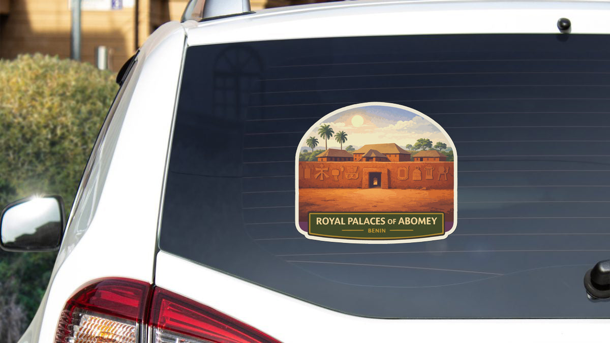 a sticker on the rear window of a car, depicting a palace with a desert landscape in the background.