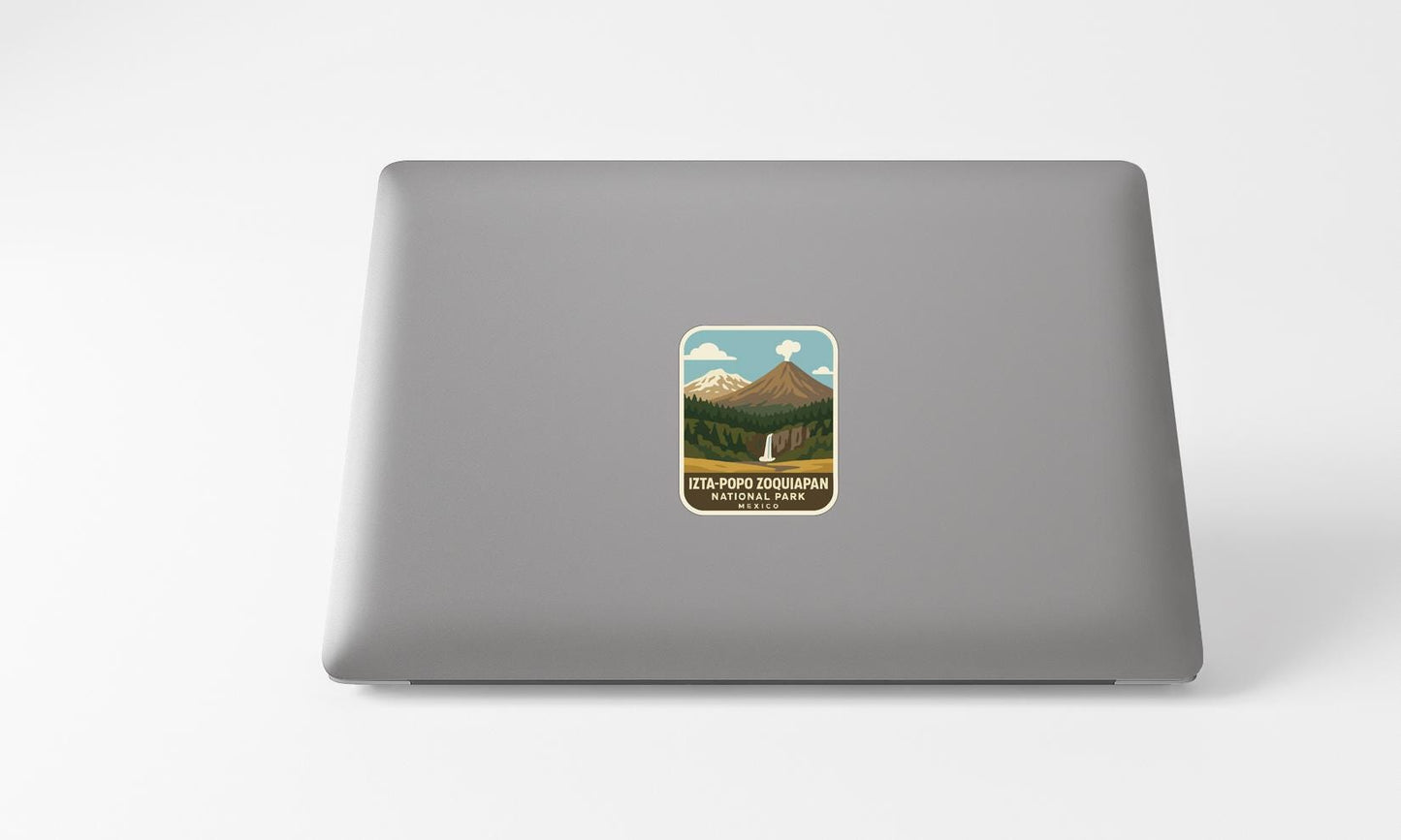 A sticker on the back of a laptop, depicting a mountain landscape with a waterfall.