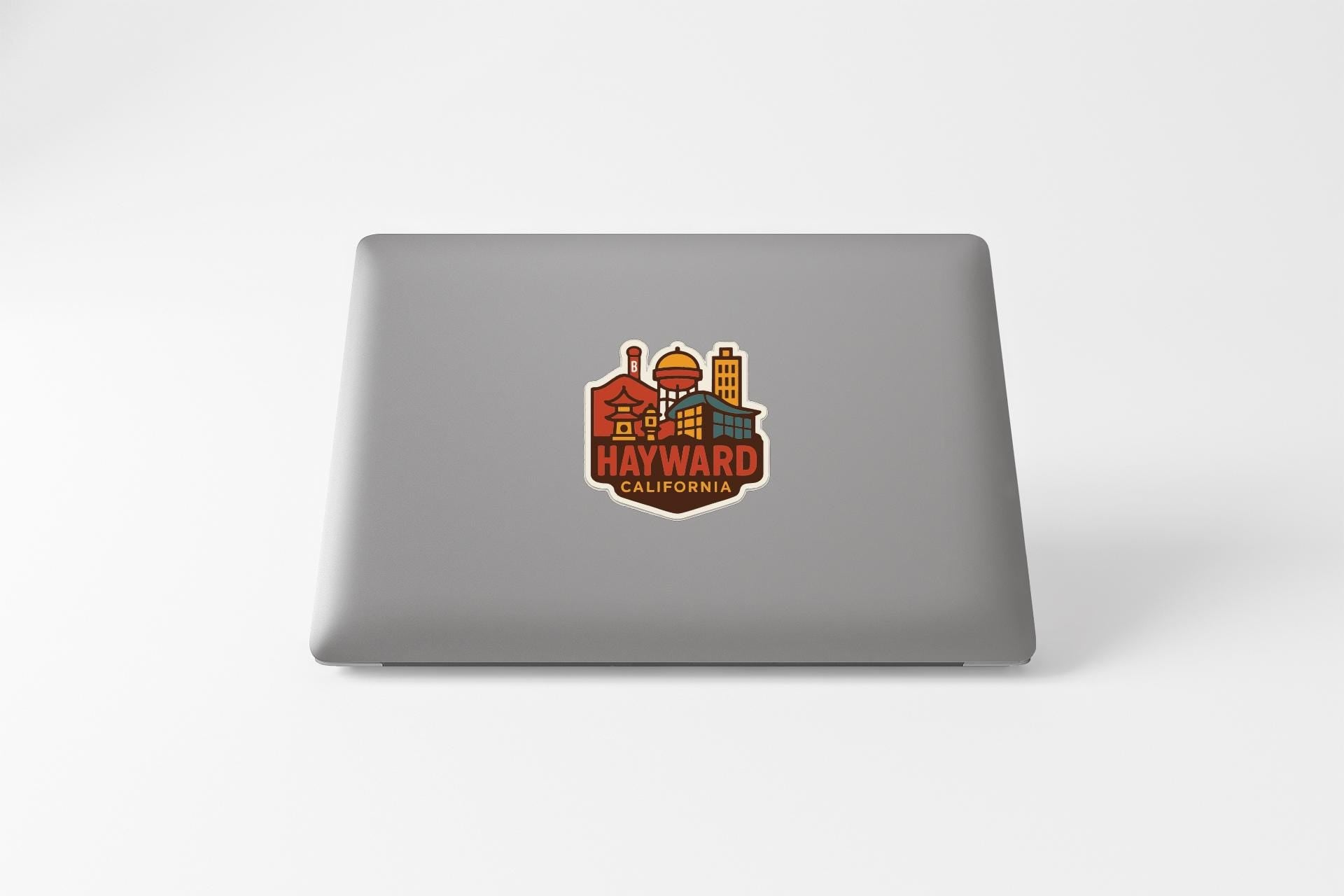 a sticker or decal of the town of Hayward, California, with various buildings and landmarks depicted in a stylized manner.