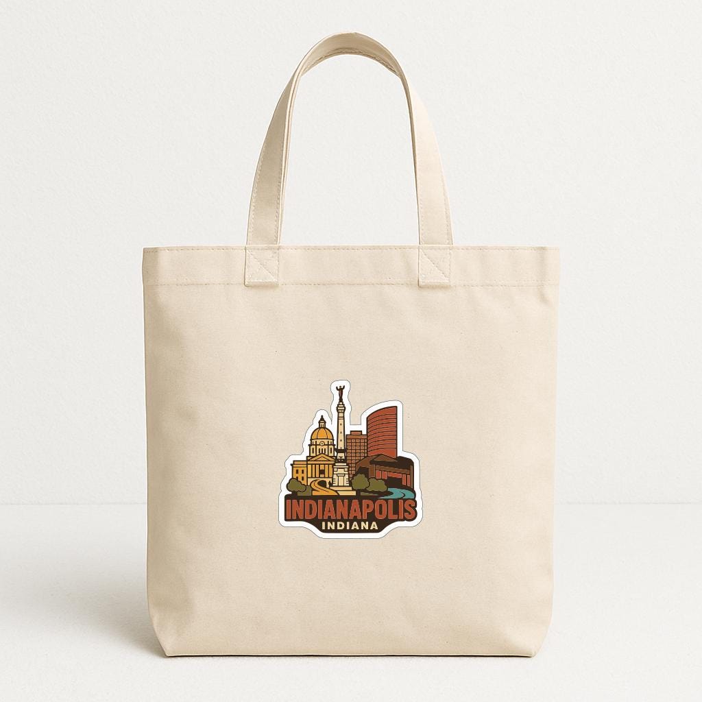 A beige tote bag with a sticker depicting the skyline of Indianapolis, Indiana.