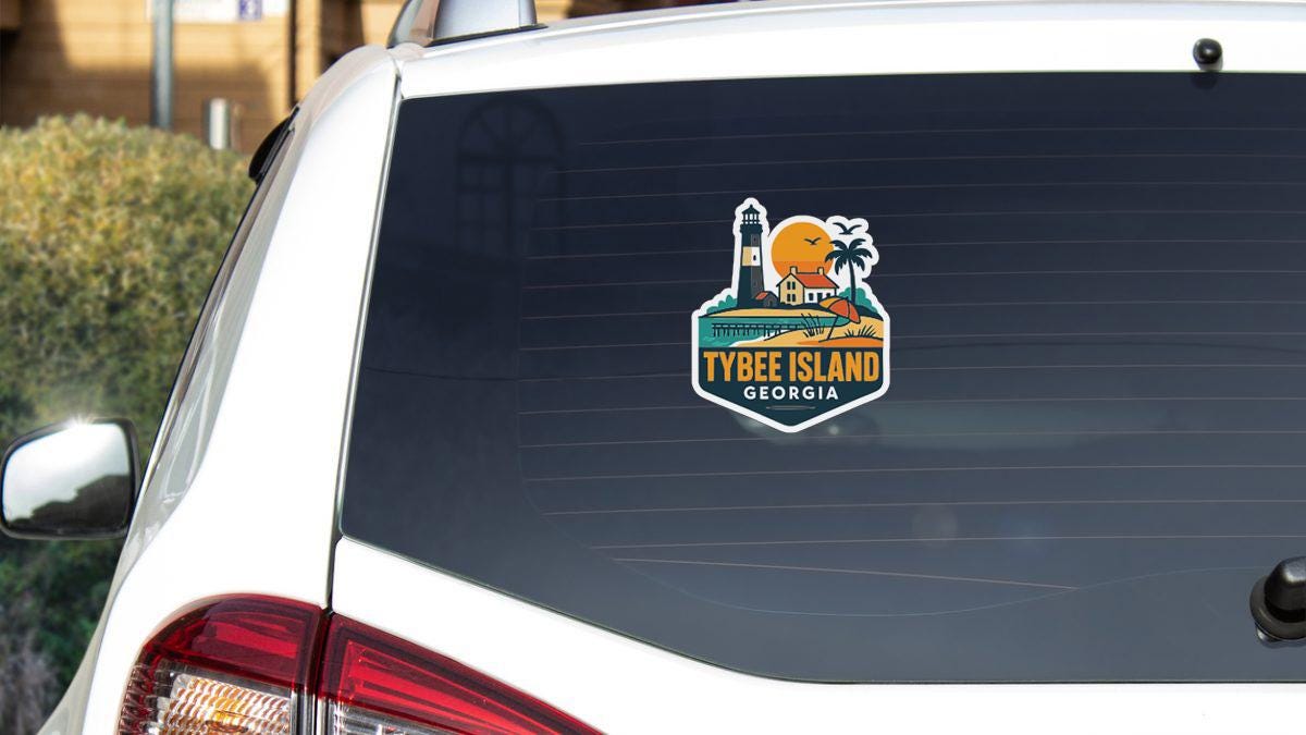 the rear window of a white car with a sticker on it, depicting a tropical island destination.