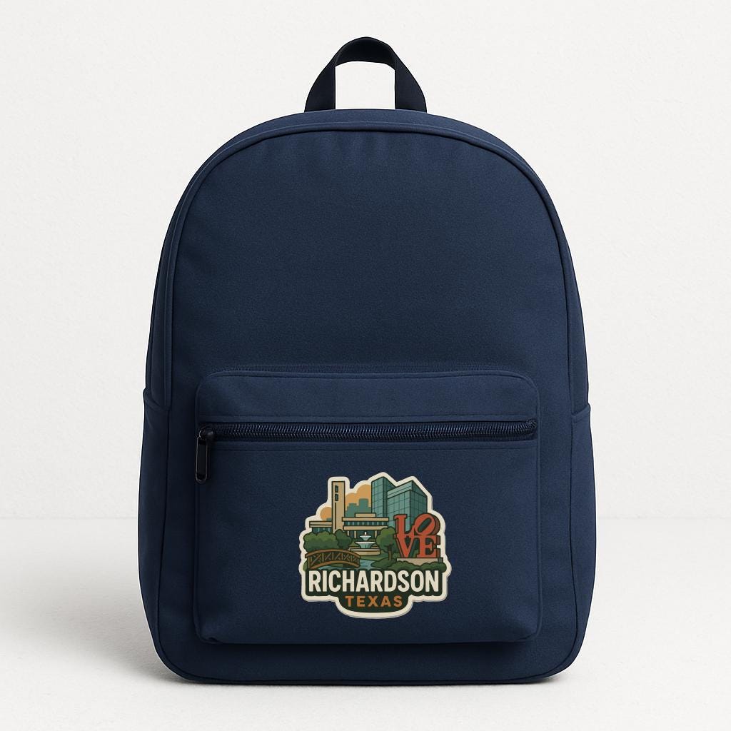 A navy blue backpack with a printed design on the front pocket, depicting a city skyline with the text "RICHARDSON TEXAS" below it.