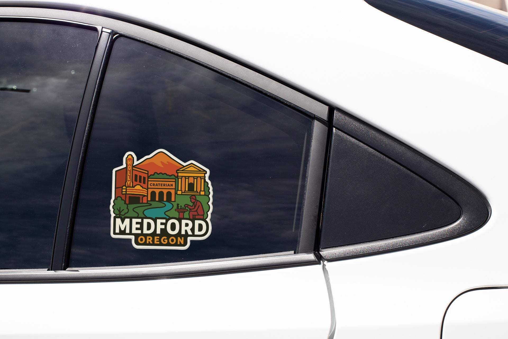 A sticker on the side of a car window, depicting a cityscape with a prominent building and the text "MEDFORD OREGON".
