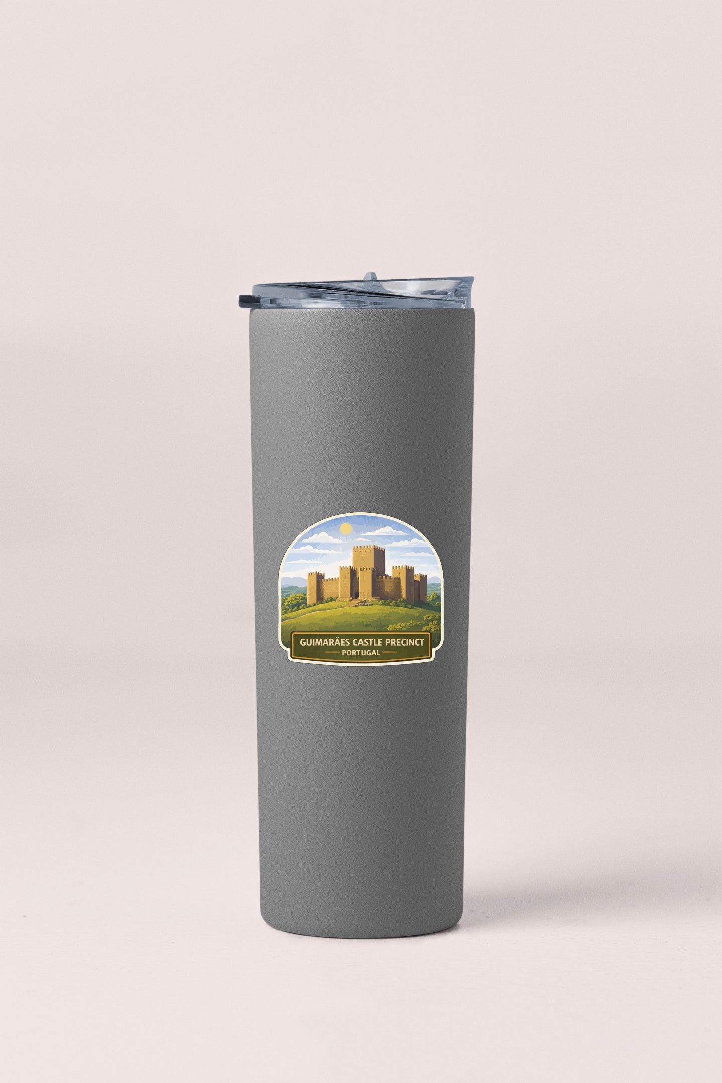 A gray insulated tumbler with a lid and a label featuring a castle and the text "Guiramabas Castle Precinct".